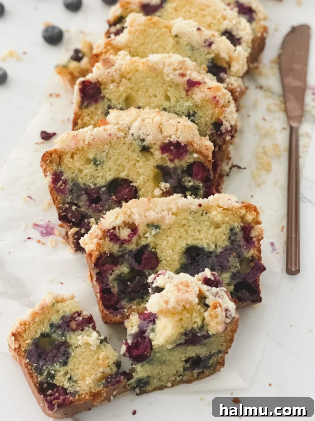 Close-up of a slice of Blueberry Streusel Coffee Cake showing the juicy blueberries and streusel