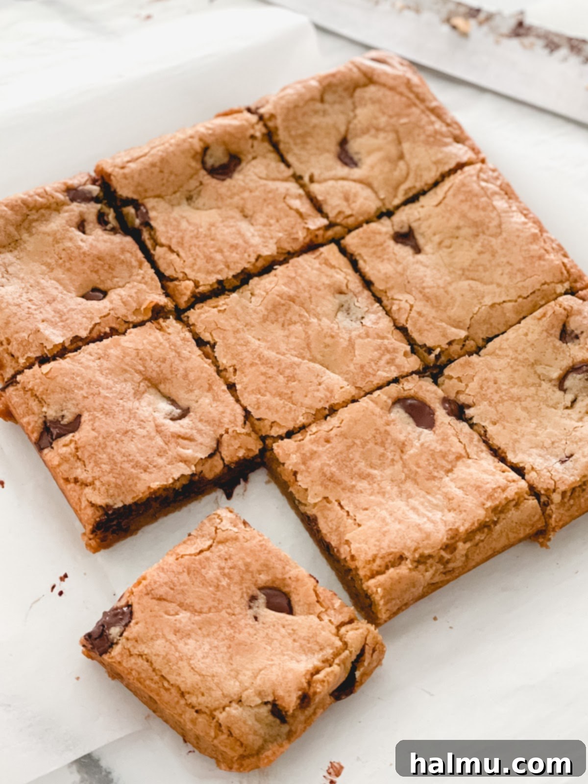 A freshly baked pan of golden brown butter blondie bars, showing a perfectly set top.