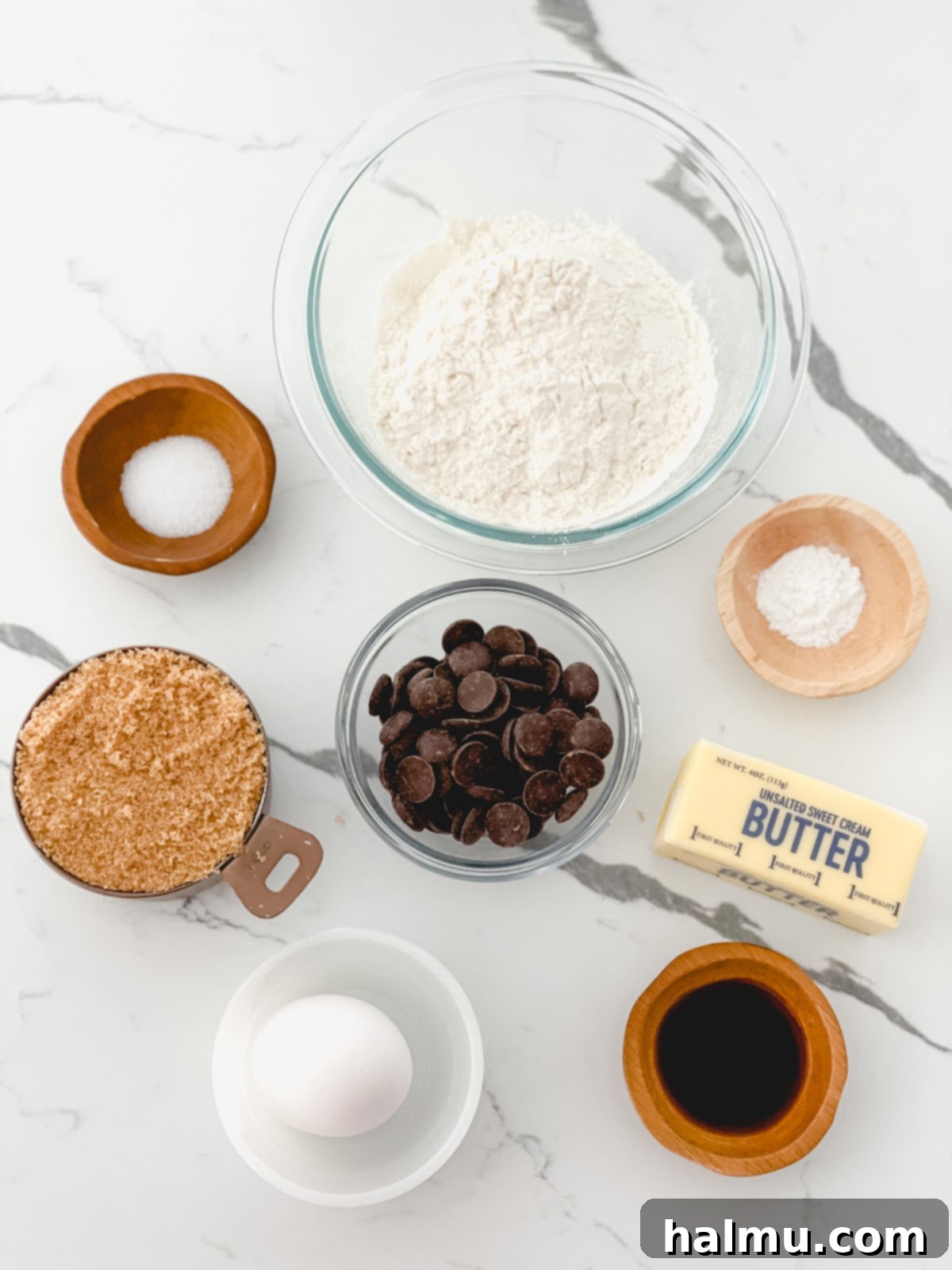 Ingredients for blondies laid out: butter, brown sugar, flour, egg, vanilla, baking powder, salt, and chocolate chips.