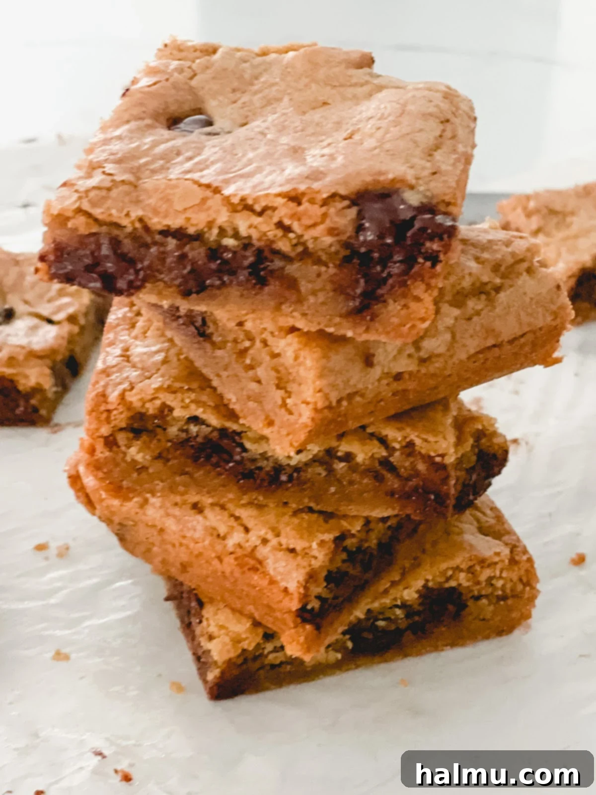 Close-up of a perfectly baked brown butter blondie bar with visible melted chocolate chunks.