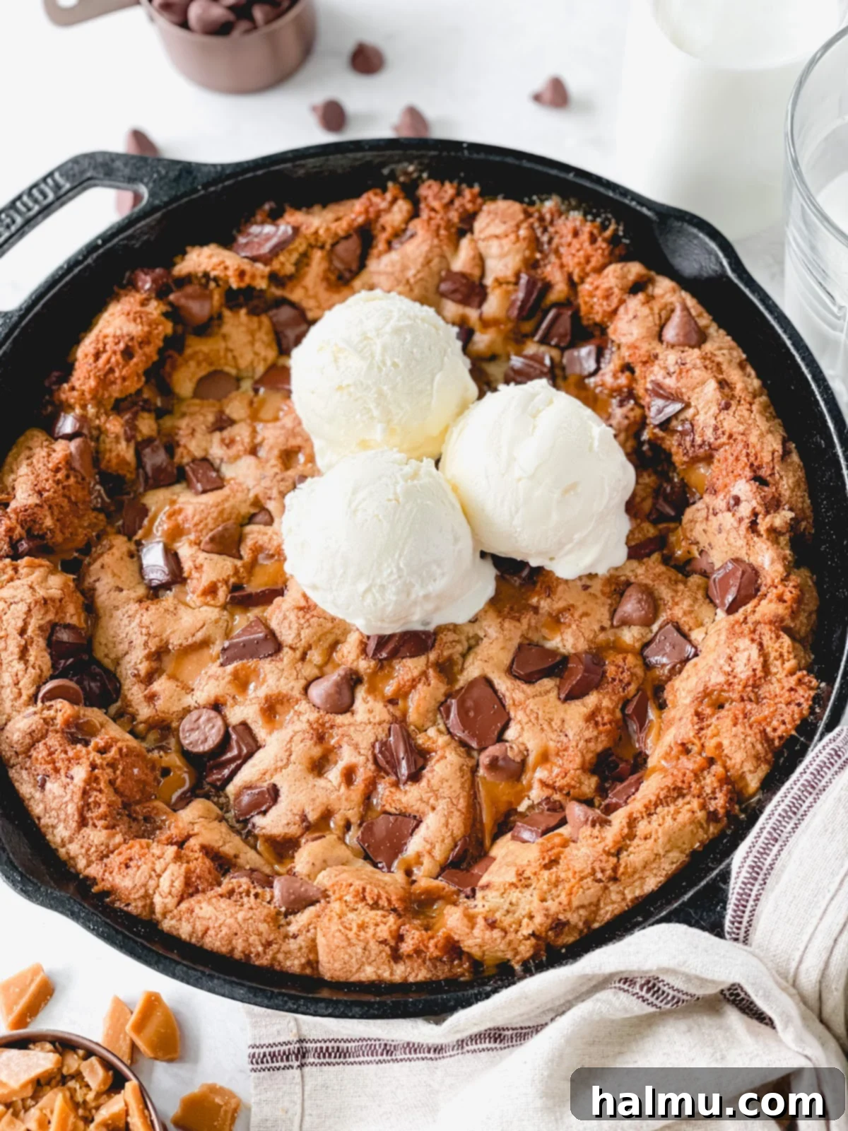 Gooey Brown Butter Toffee Skillet Cookie 7 A close-up of a slice of warm brown butter toffee skillet cookie, showcasing its gooey interior and melted chocolate.