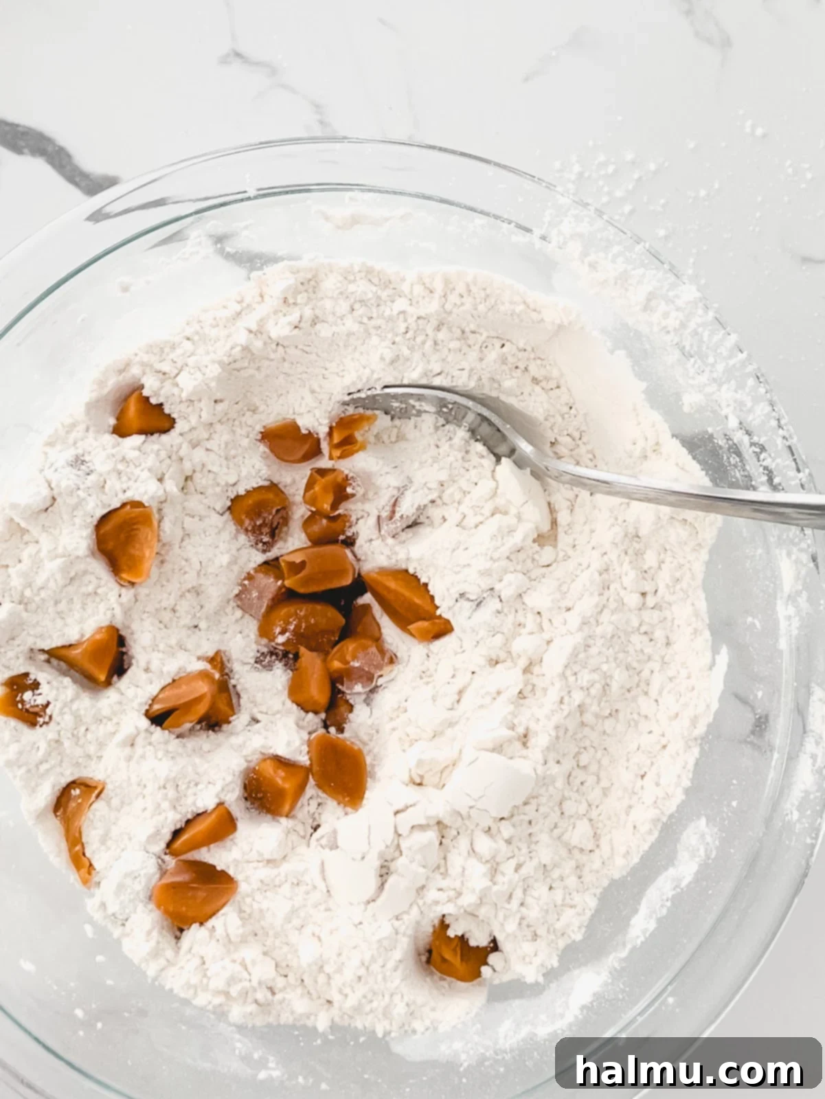 Scooped cookie dough balls on a parchment-lined baking sheet, ready for chilling
