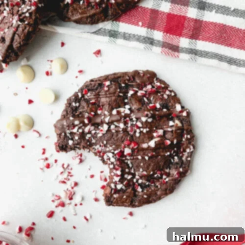 Peppermint Burst Chocolate Bites 3 A festive stack of Chocolate Candy Cane Crunch Cookies on a cooling rack.