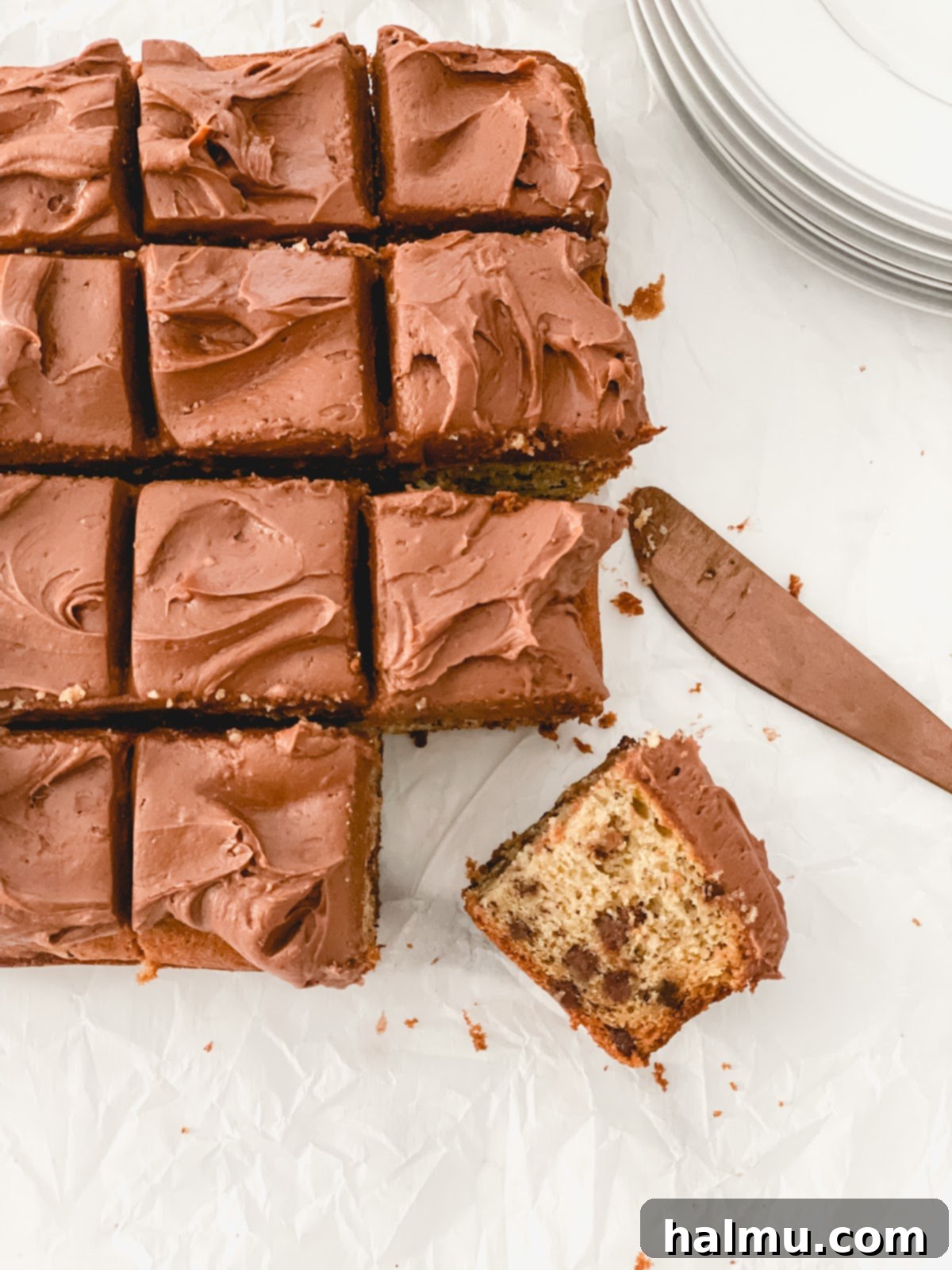 Slice of chocolate chip banana cake with chocolate cream cheese frosting
