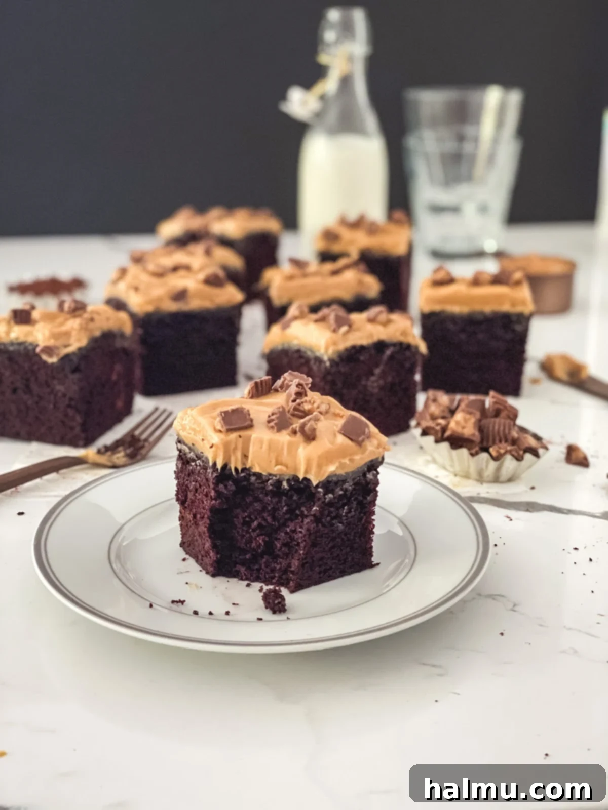 Chocolate Peanut Butter Dream Treat 5 Ingredients for the Chocolate Peanut Butter Snack Cake laid out, including butter, eggs, flour, cocoa, and a jar of peanut butter.