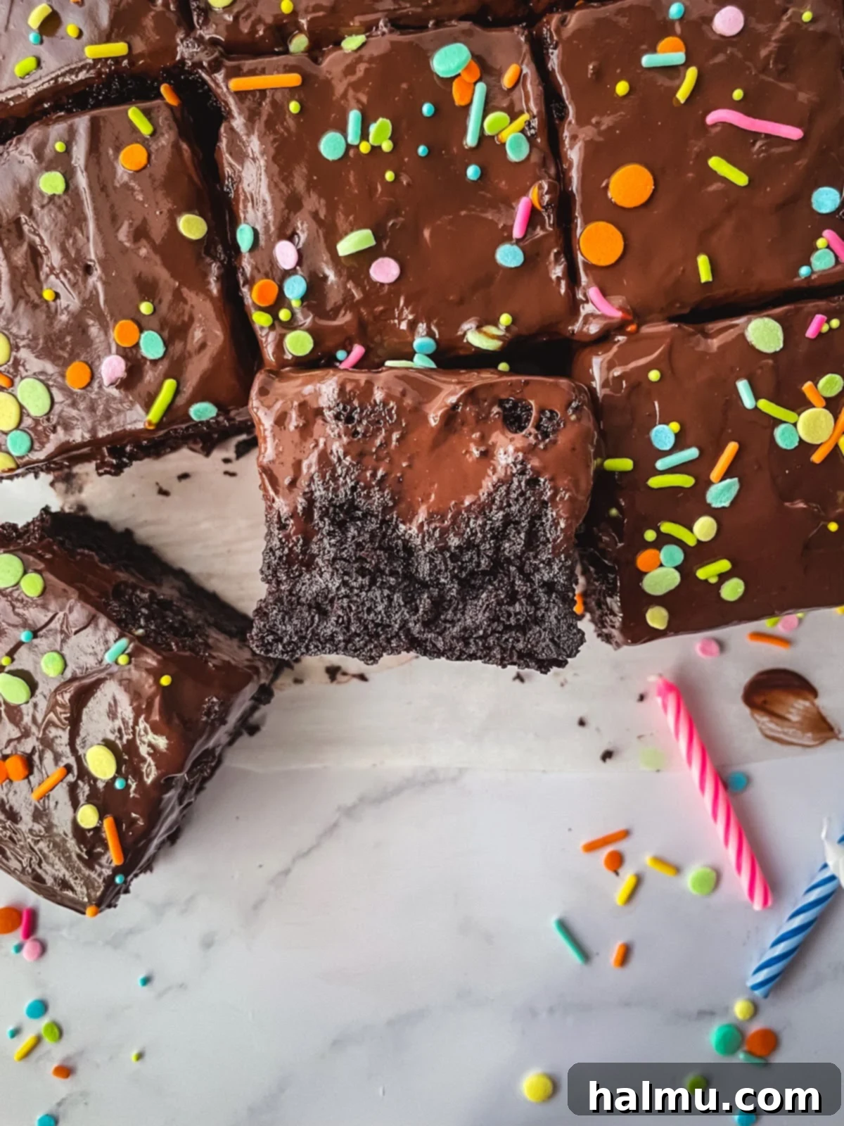 A baked chocolate cake with carefully poked holes, ready to absorb the rich chocolate pudding.