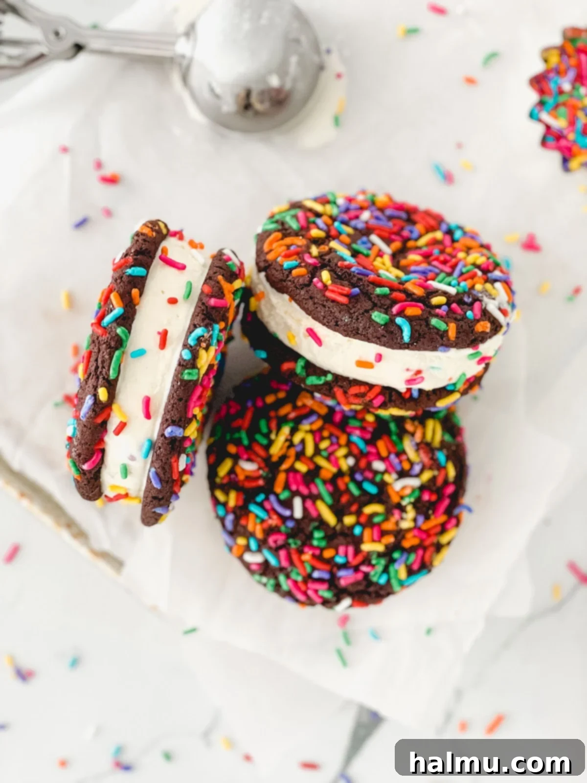 Chocolate Sprinkle Cookie Ice Cream Stacks 9 A stack of three chocolate sprinkle cookie ice cream sandwiches on a plate.