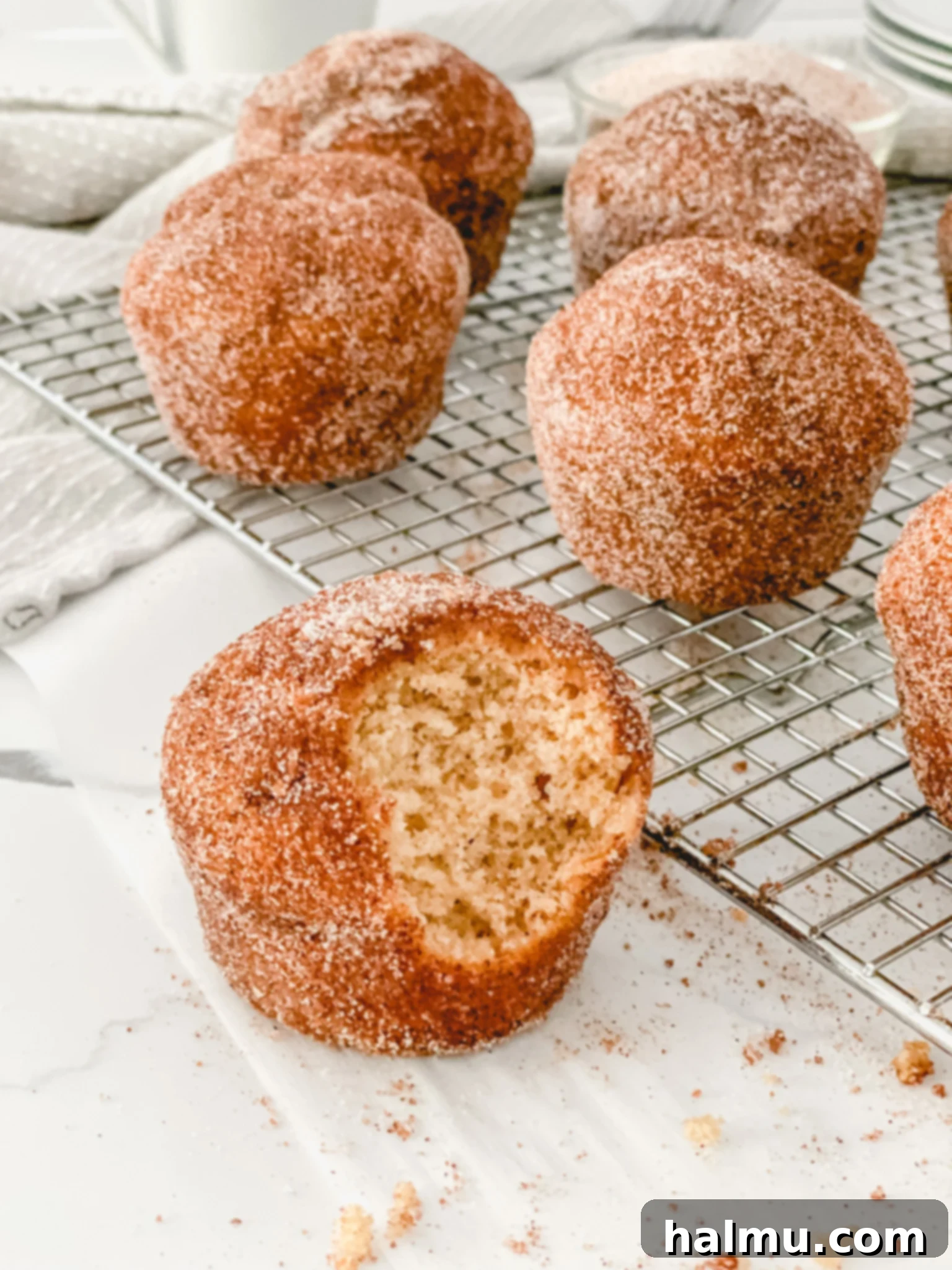 Warm Cinnamon Sugar Donut Muffins on a wooden board