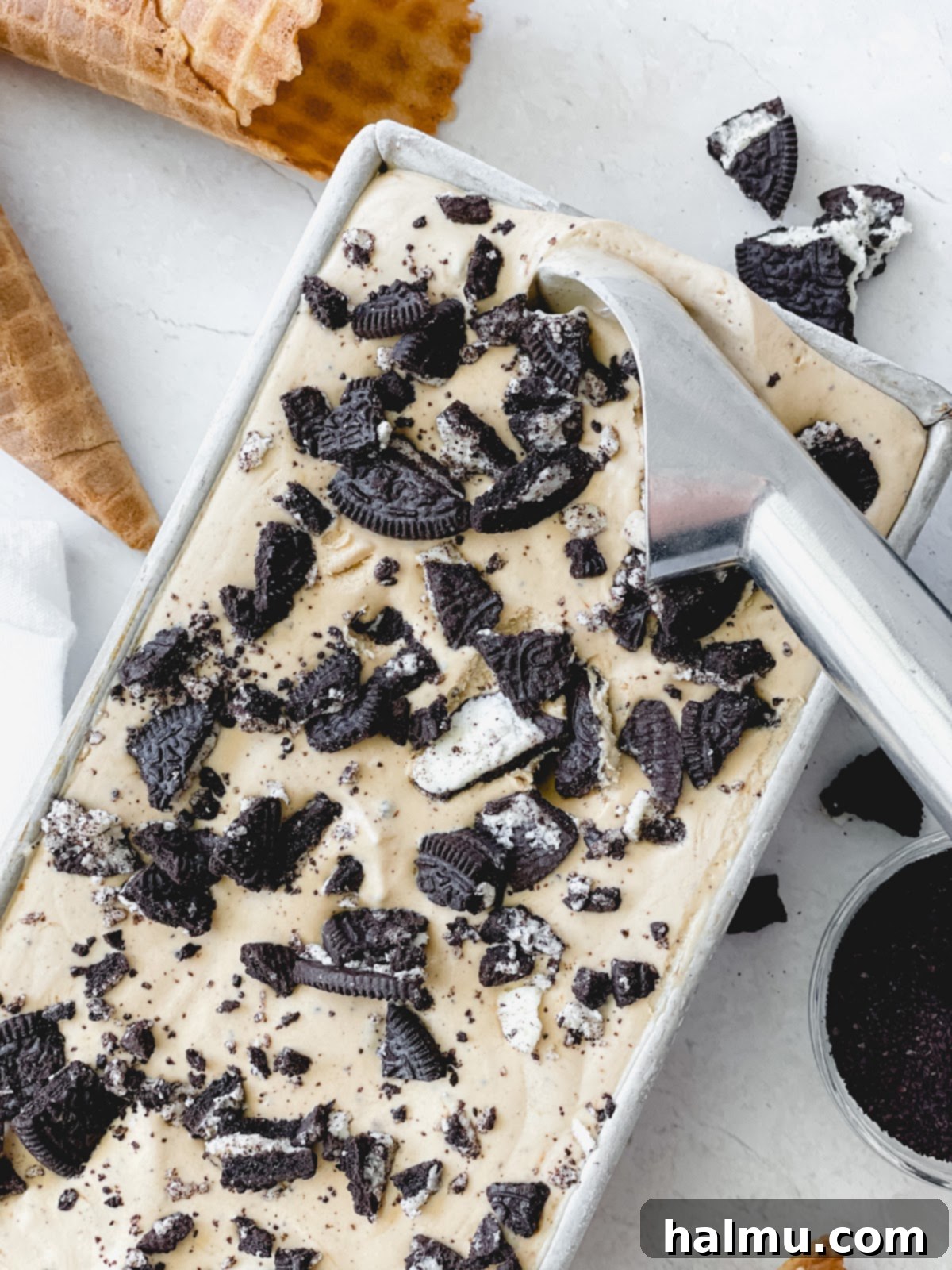 A scoop of Espresso Oreo ice cream in a waffle cone.