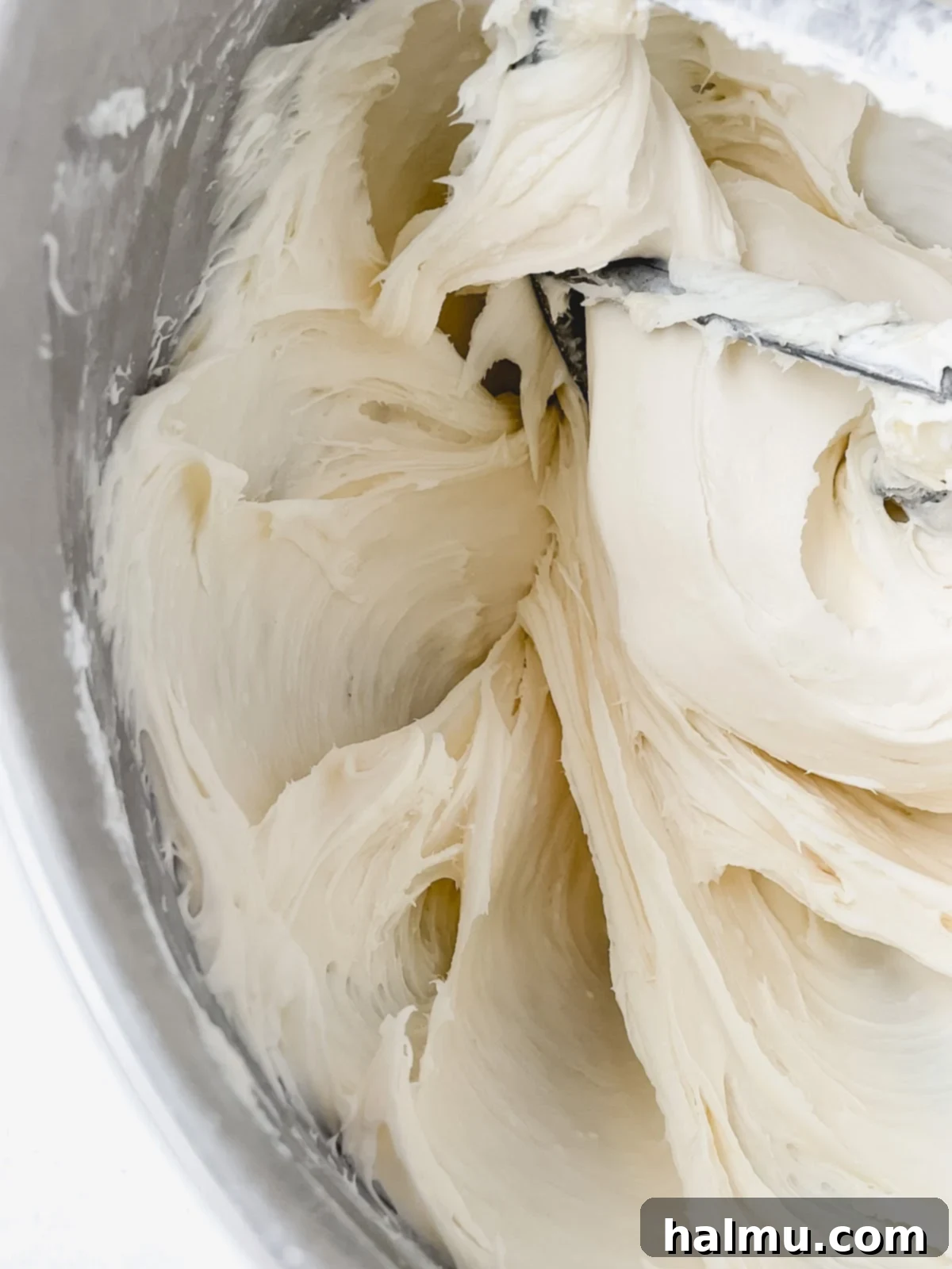 Ginger Molasses Sandwich Cookies 5 A piping bag filled with cream cheese frosting, ready to assemble cookie sandwiches.