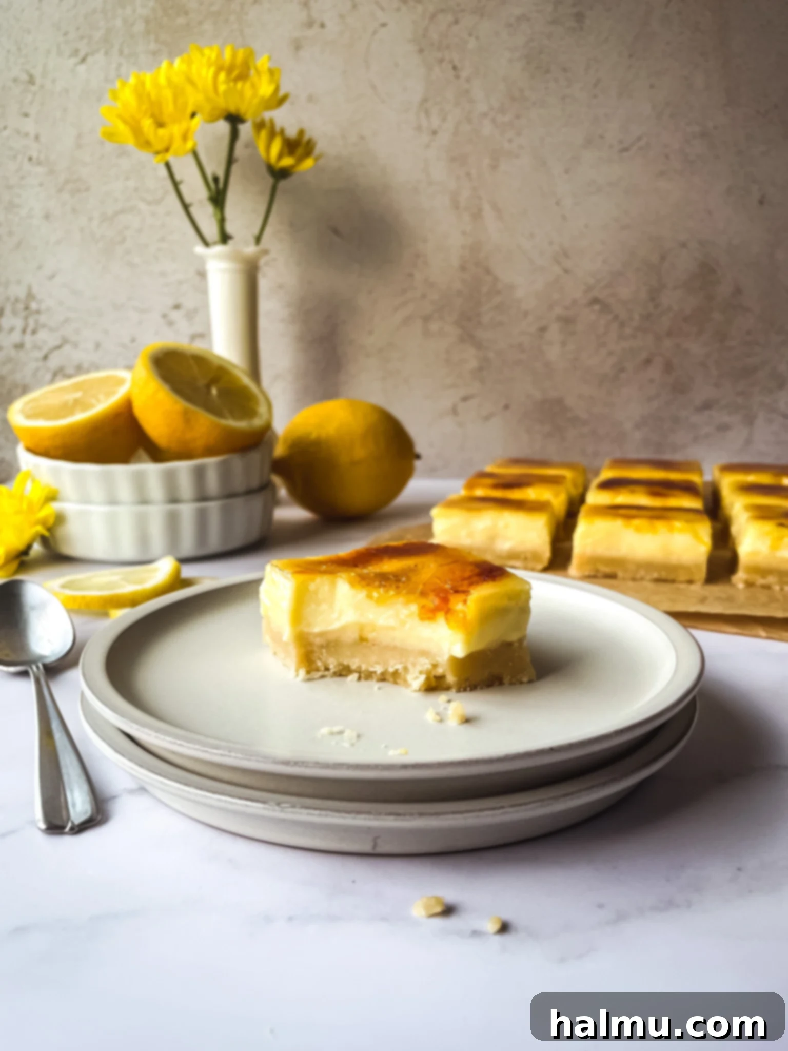 Close-up of a Lemon Brûlée Bar, showing the golden caramelized sugar topping and creamy yellow lemon custard.