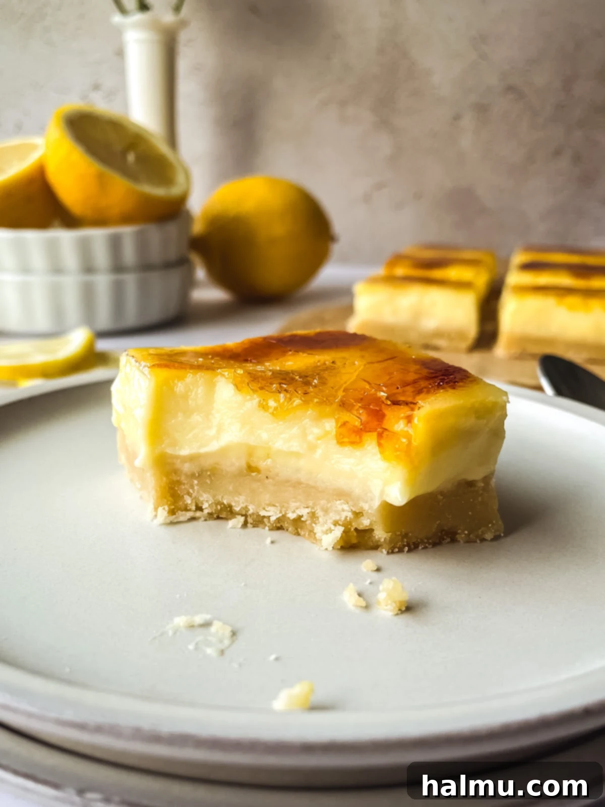 A stack of Lemon Brûlée Bars with a crisp caramelized top, ready to be served.