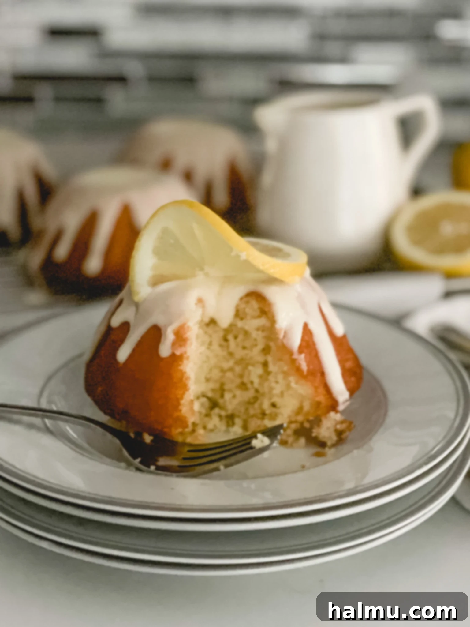 Freshly baked mini lemon bundt cakes on a cooling rack
