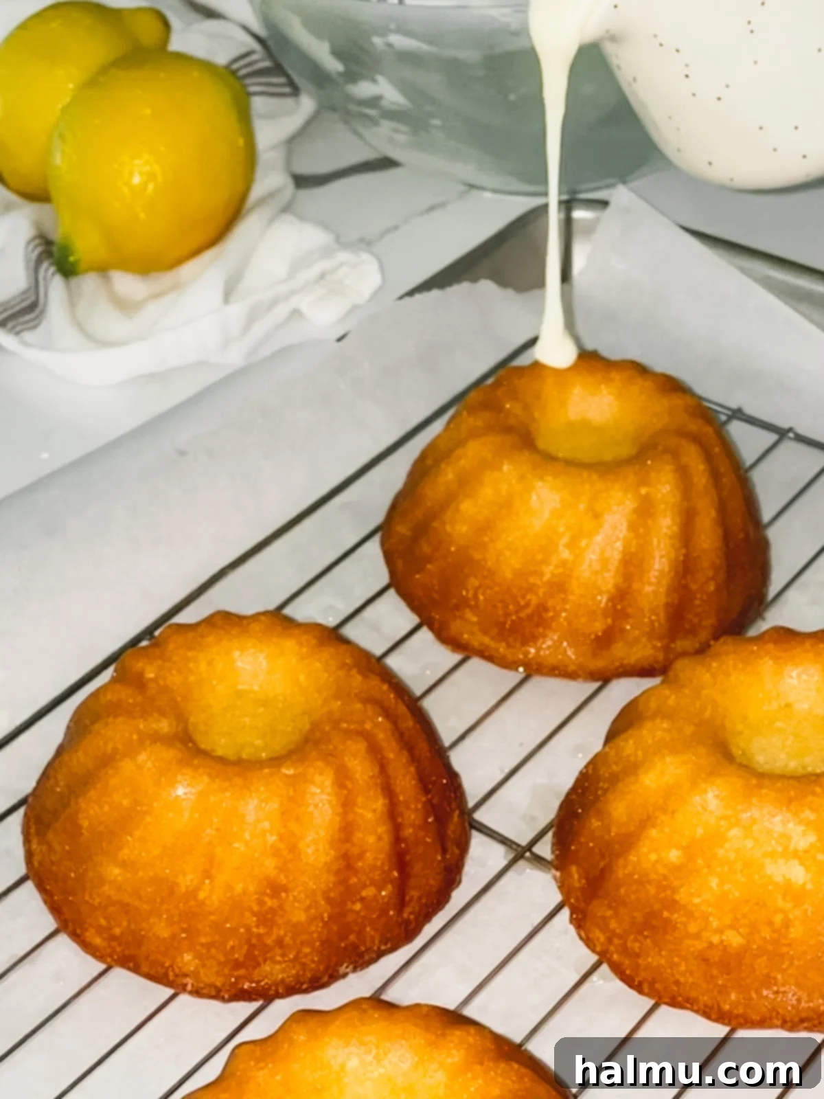 Plated mini lemon bundt cake with glaze and lemon slice