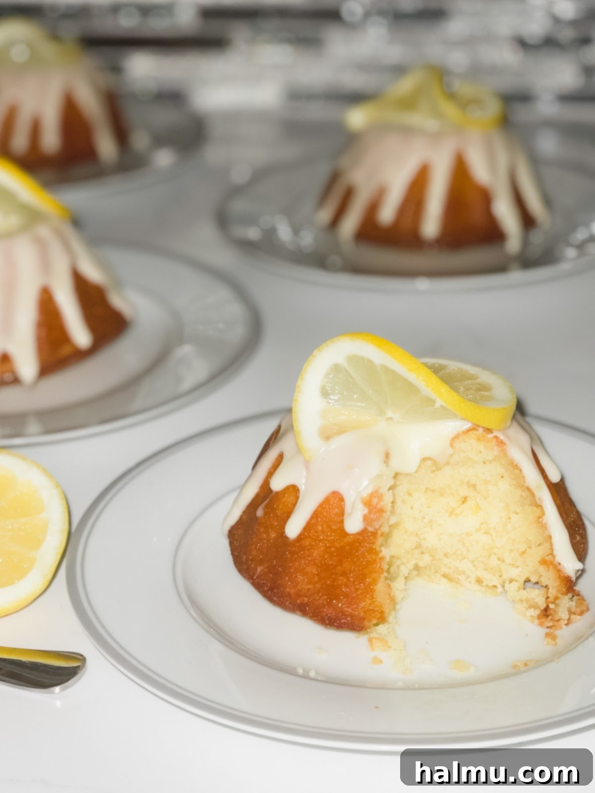 Close-up of a lemon bundt cake with a slice removed, showing moist interior