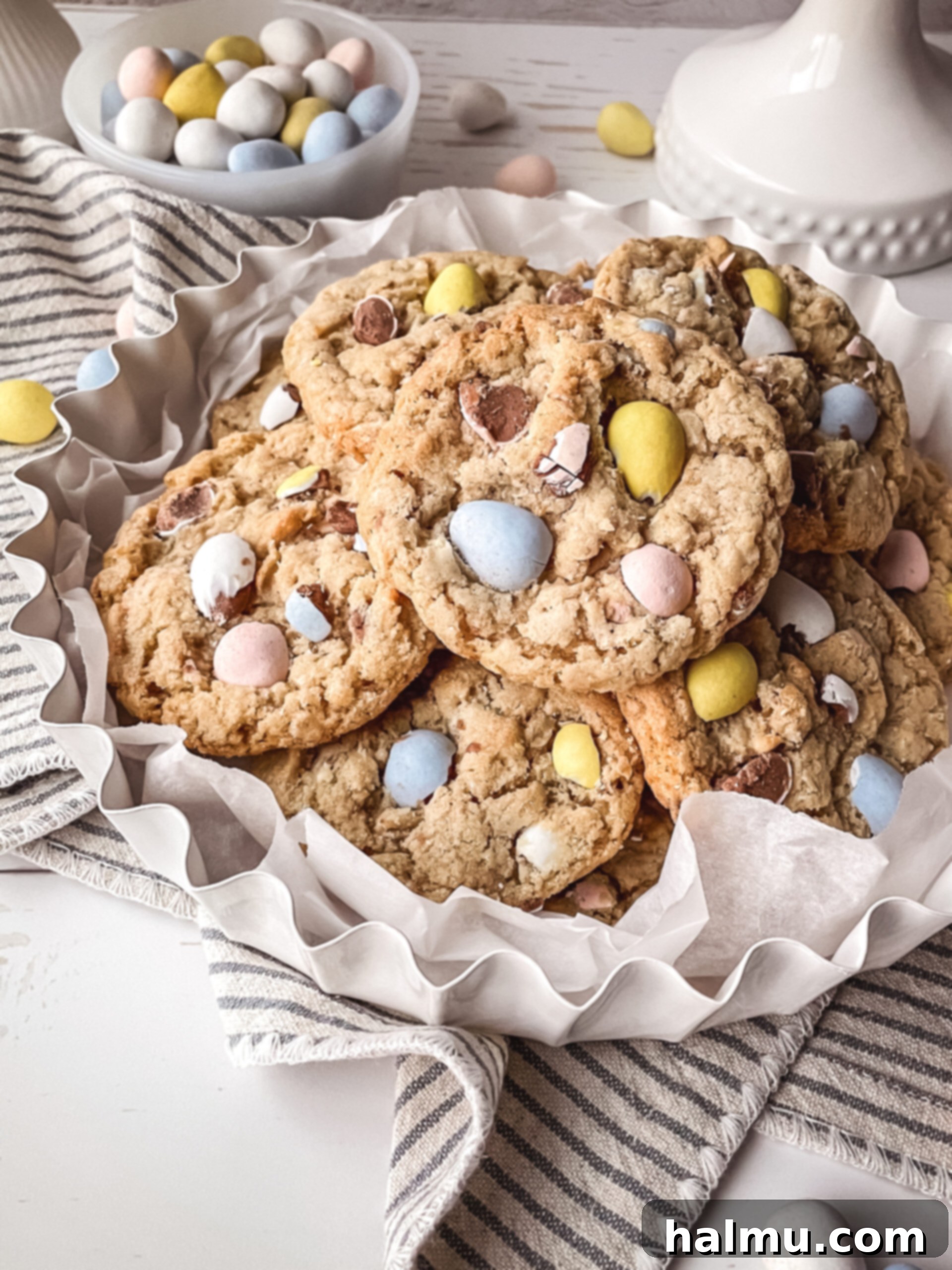 Mini Egg Oatmeal Cookies 3 A stack of golden brown Mini Egg Oatmeal Cookies, showing the oats and chocolate chunks.