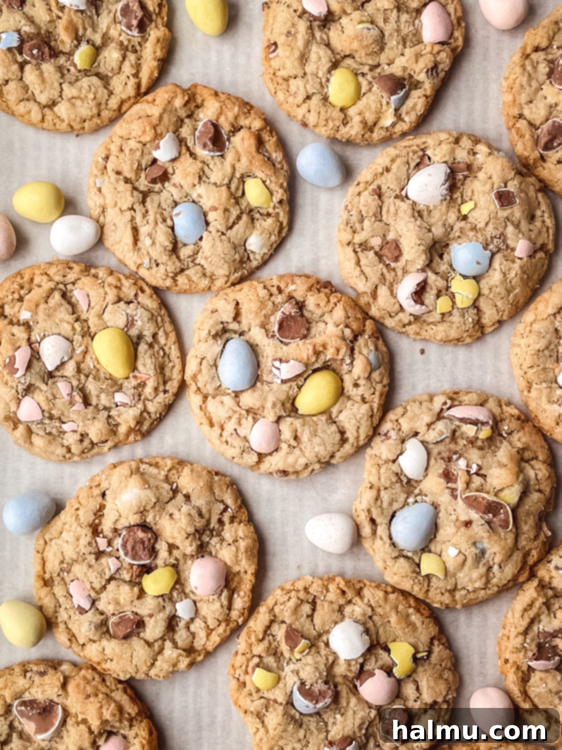 Mini Egg Oatmeal Cookies 5 A hand reaching for a Mini Egg Oatmeal Cookie on a wire rack.