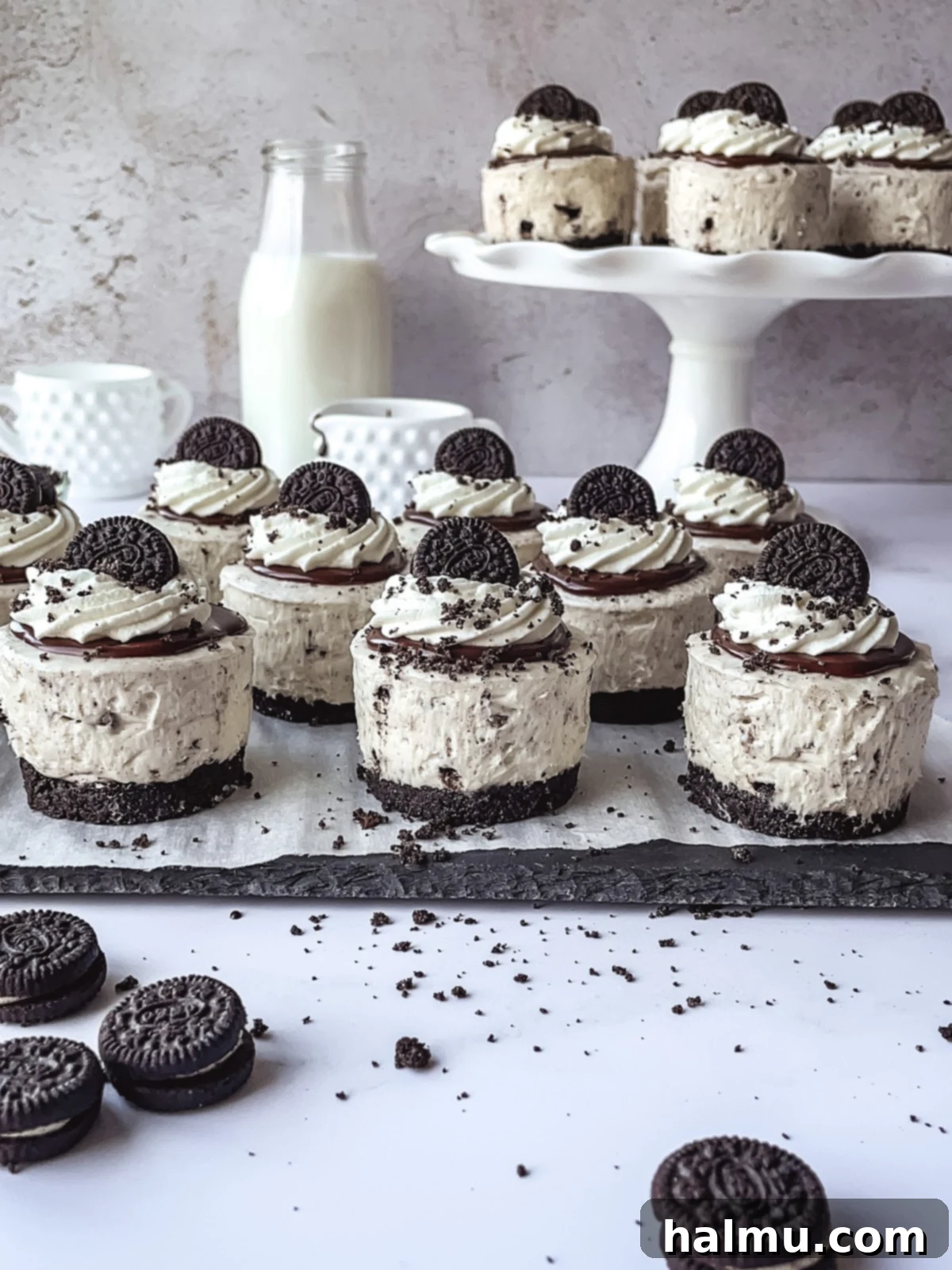 Close-up of a Mini Oreo Cheesecake on a marble surface with a fork, ready to be eaten.