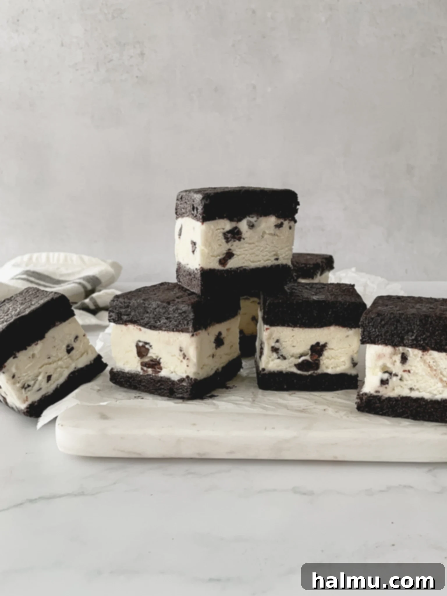 Refreshing Mint Chocolate Chip Ice Cream Delights 2 Delicious Mint Chocolate Chip Ice Cream Sandwich on a plate, showcasing fudgy brownie layers and a thick layer of green ice cream.