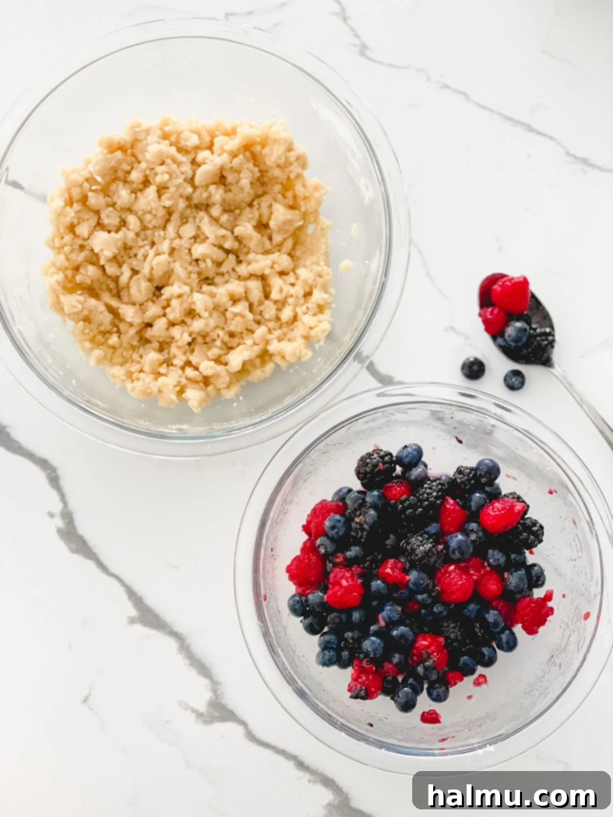 Sweet Berry Crumble Bars 7 Step-by-step image showing how to press the streusel base into a baking pan.