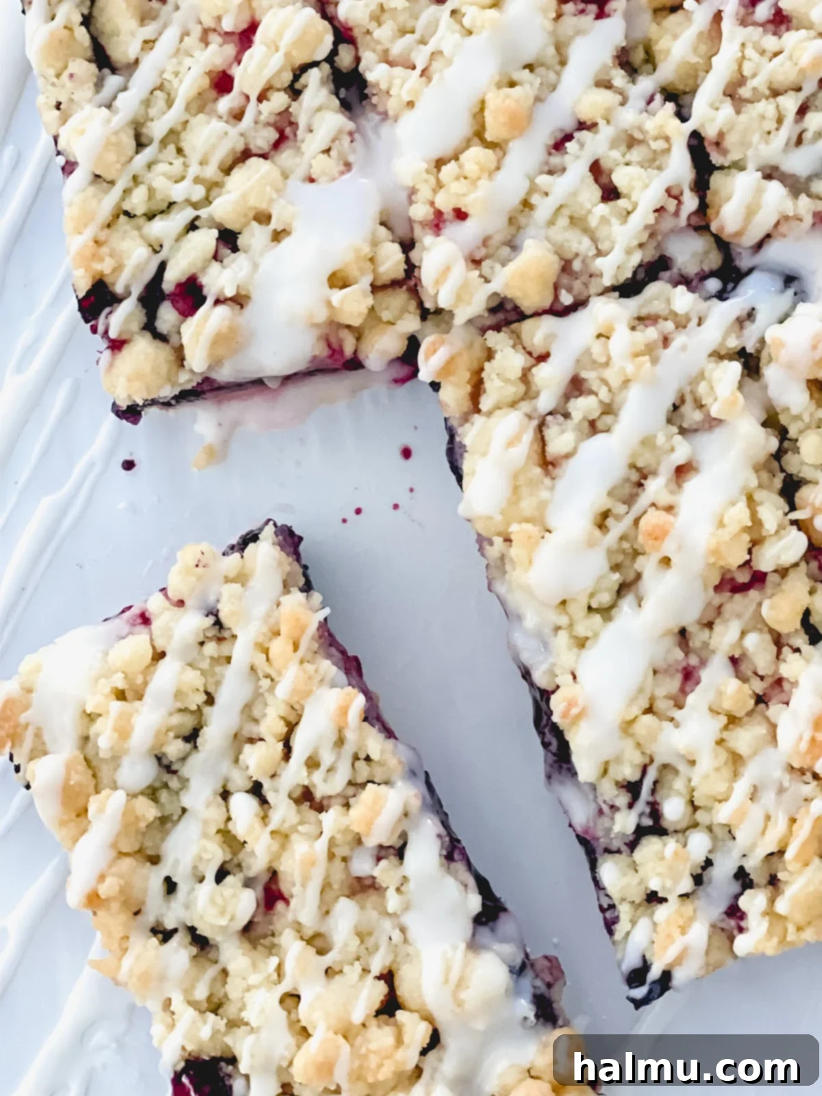 Sweet Berry Crumble Bars 9 Finished Mixed Berry Streusel Bars with lemon glaze, arranged on a cooling rack.