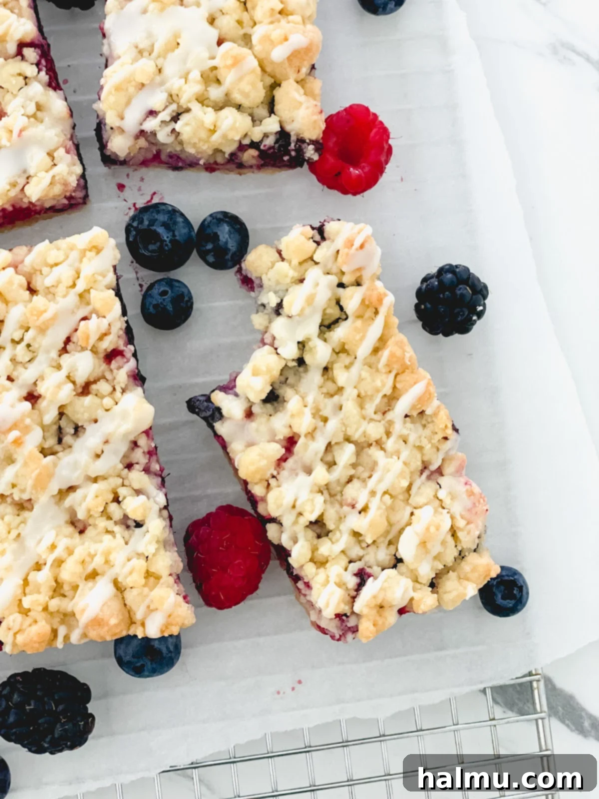 Sweet Berry Crumble Bars 10 A stack of three Mixed Berry Streusel Bars, showing off the generous berry filling and crumbly topping.