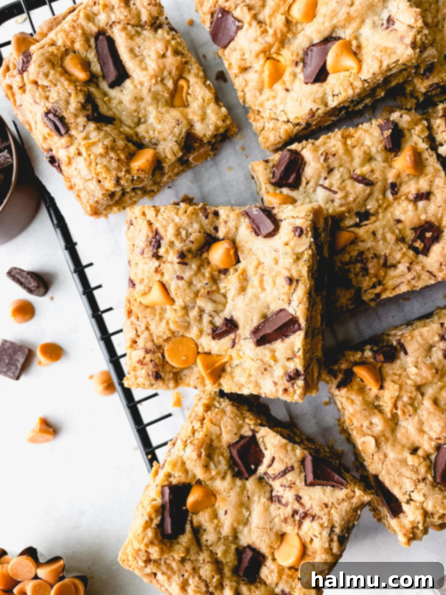 Close-up of golden brown oatmeal butterscotch blondies with visible oats, butterscotch chips, and chocolate chunks.