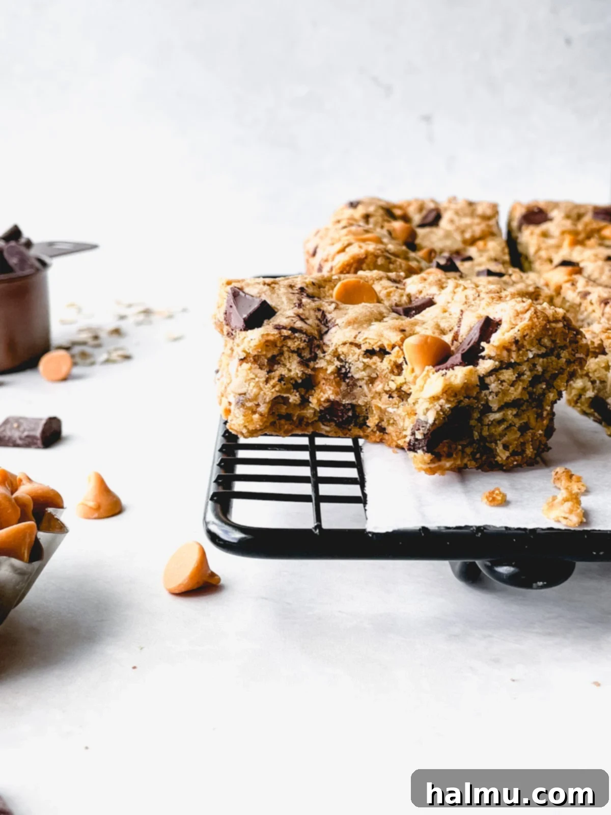 A stack of freshly baked oatmeal butterscotch blondies on a cooling rack.
