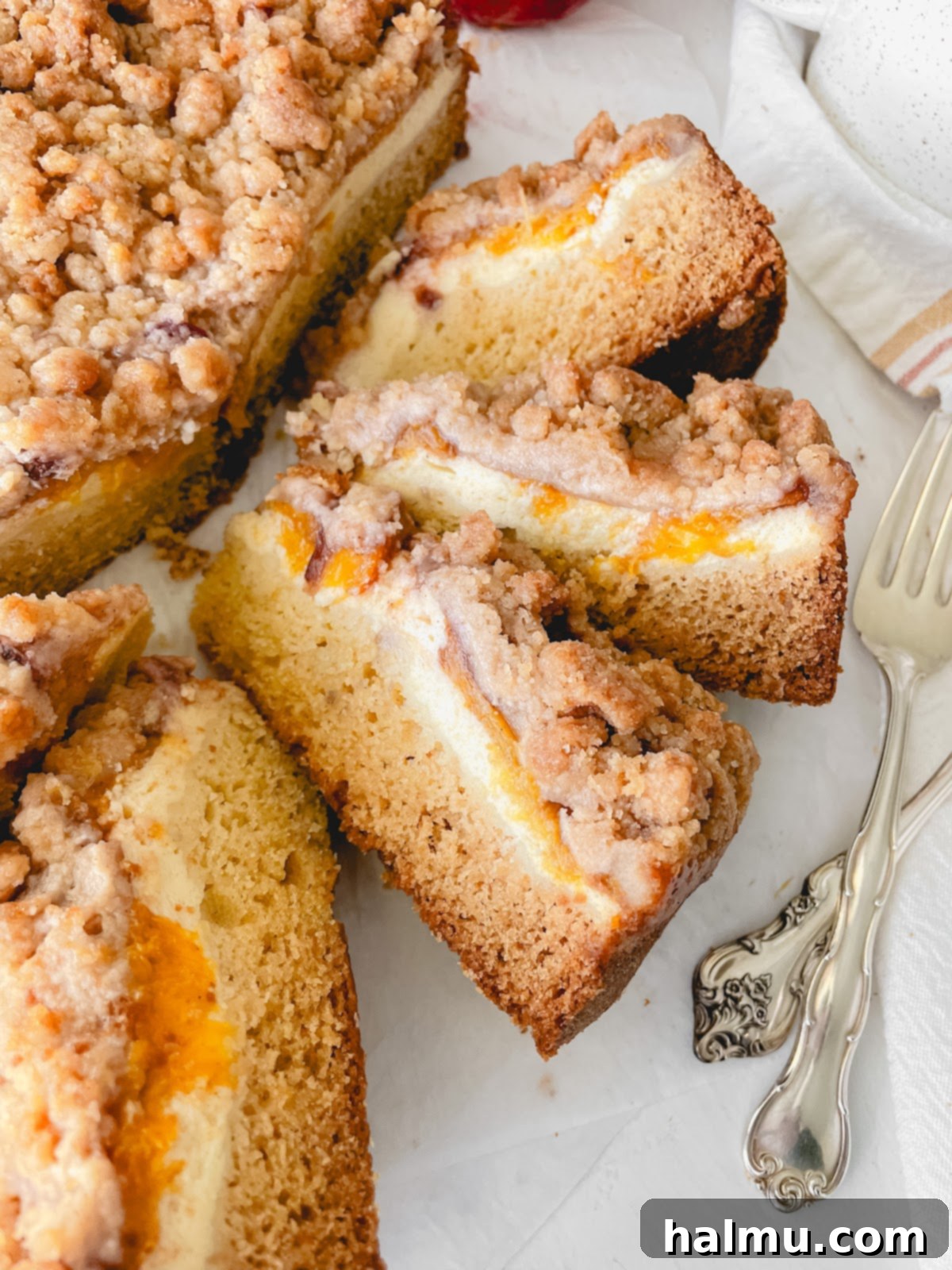 Heavenly Peach and Cream Crumb Cake 3 Close-up of the Peaches & Cream Crumb Cake, highlighting the thick, buttery crumb topping and visible peach slices underneath.