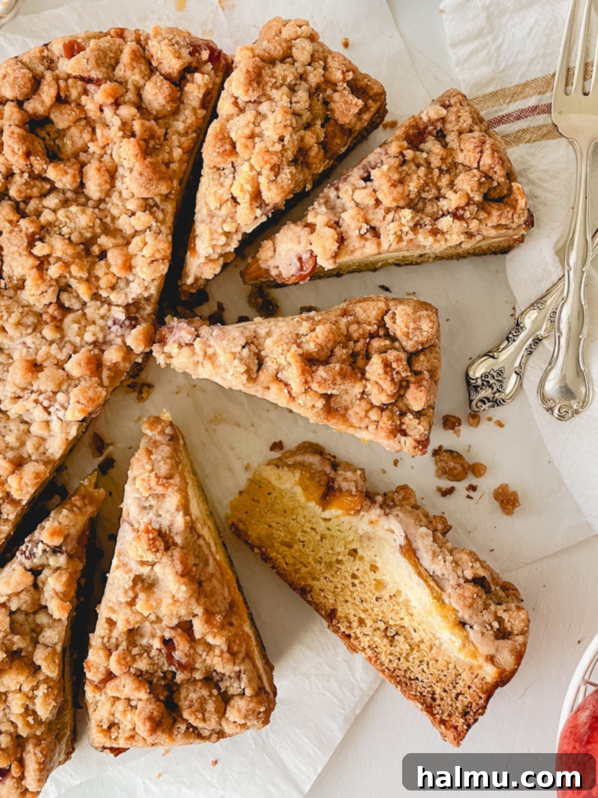 Heavenly Peach and Cream Crumb Cake 6 A beautiful top-down shot of the Peaches & Cream Crumb Cake, showcasing the golden crumb topping and hints of peaches peeking through.
