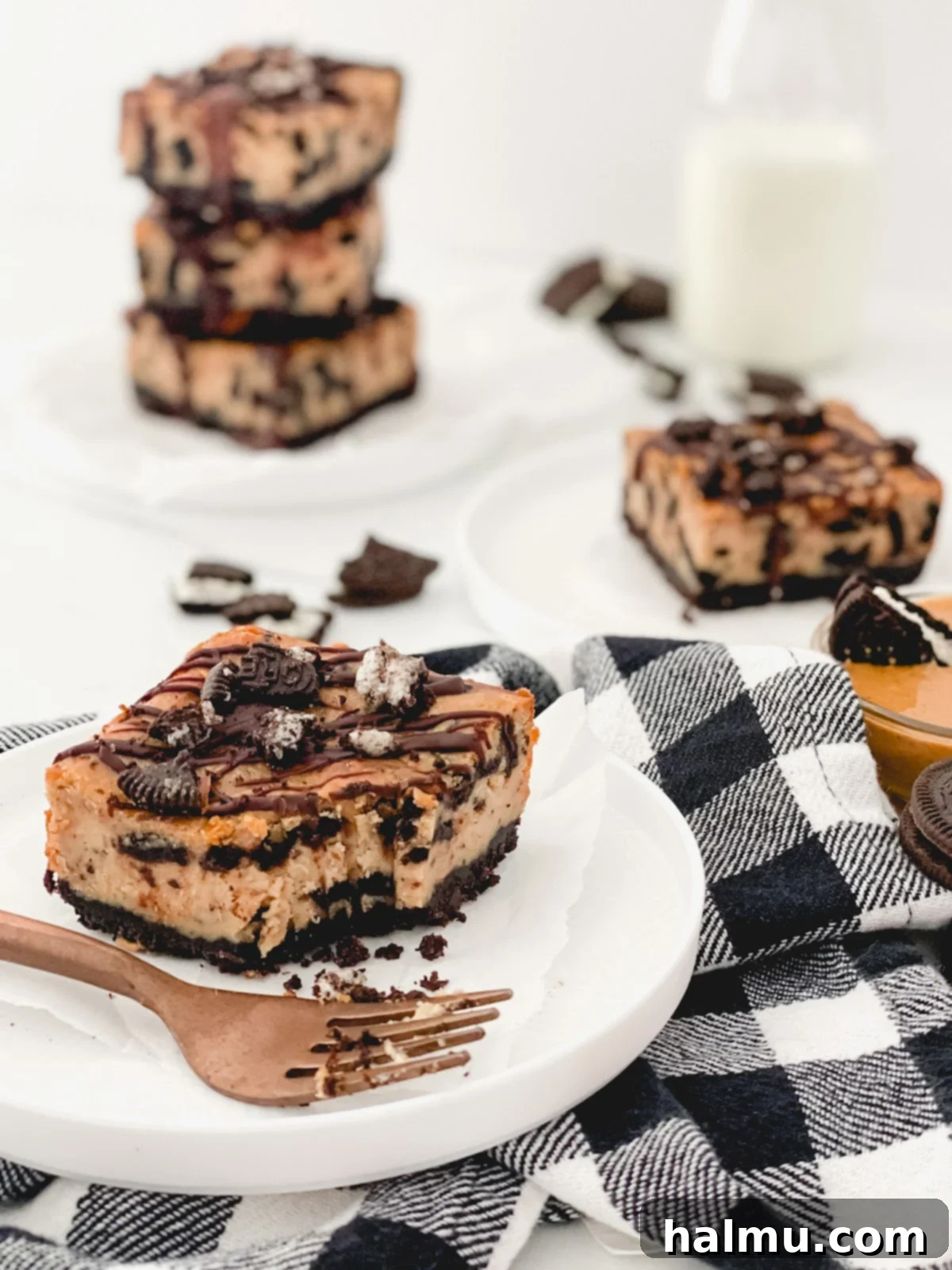A tray of freshly baked Peanut Butter Oreo Cheesecake Bars cooling on a wire rack.