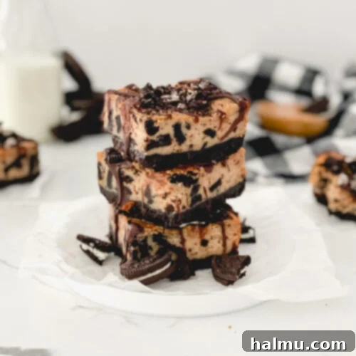 Final plated Peanut Butter Oreo Cheesecake Bars with chocolate drizzle.