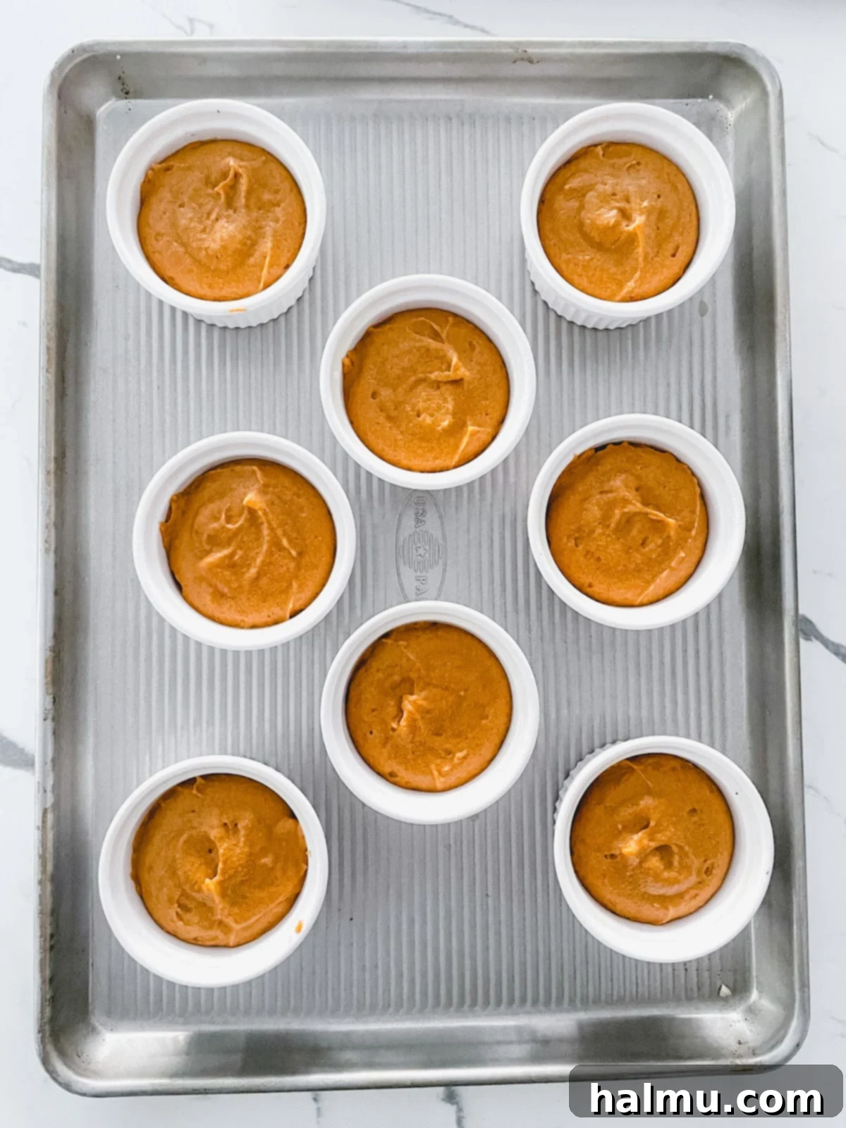 Caramel Pecan Pumpkin Flips 6 Pumpkin cake batter scooped into ramekins with pecan topping