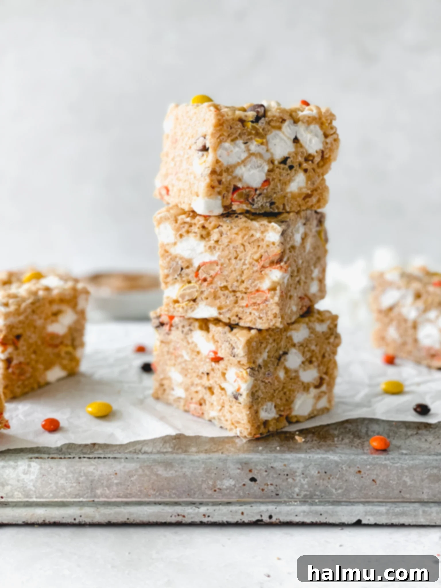 Reeses Pieces Crispy Treats 2 Close-up of freshly made Reese's Pieces Rice Krispie Treats, stacked on a cooling rack.