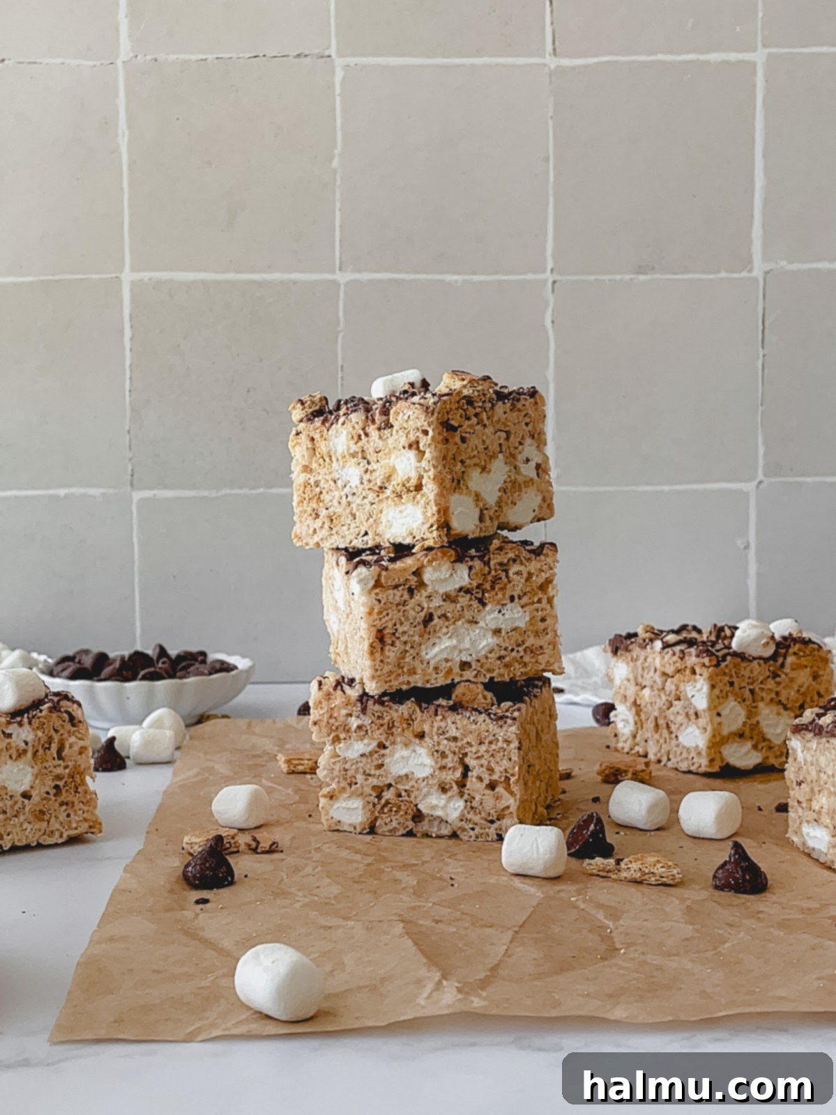 A plate with a single S'mores Rice Krispie Treat, cut and ready to eat.