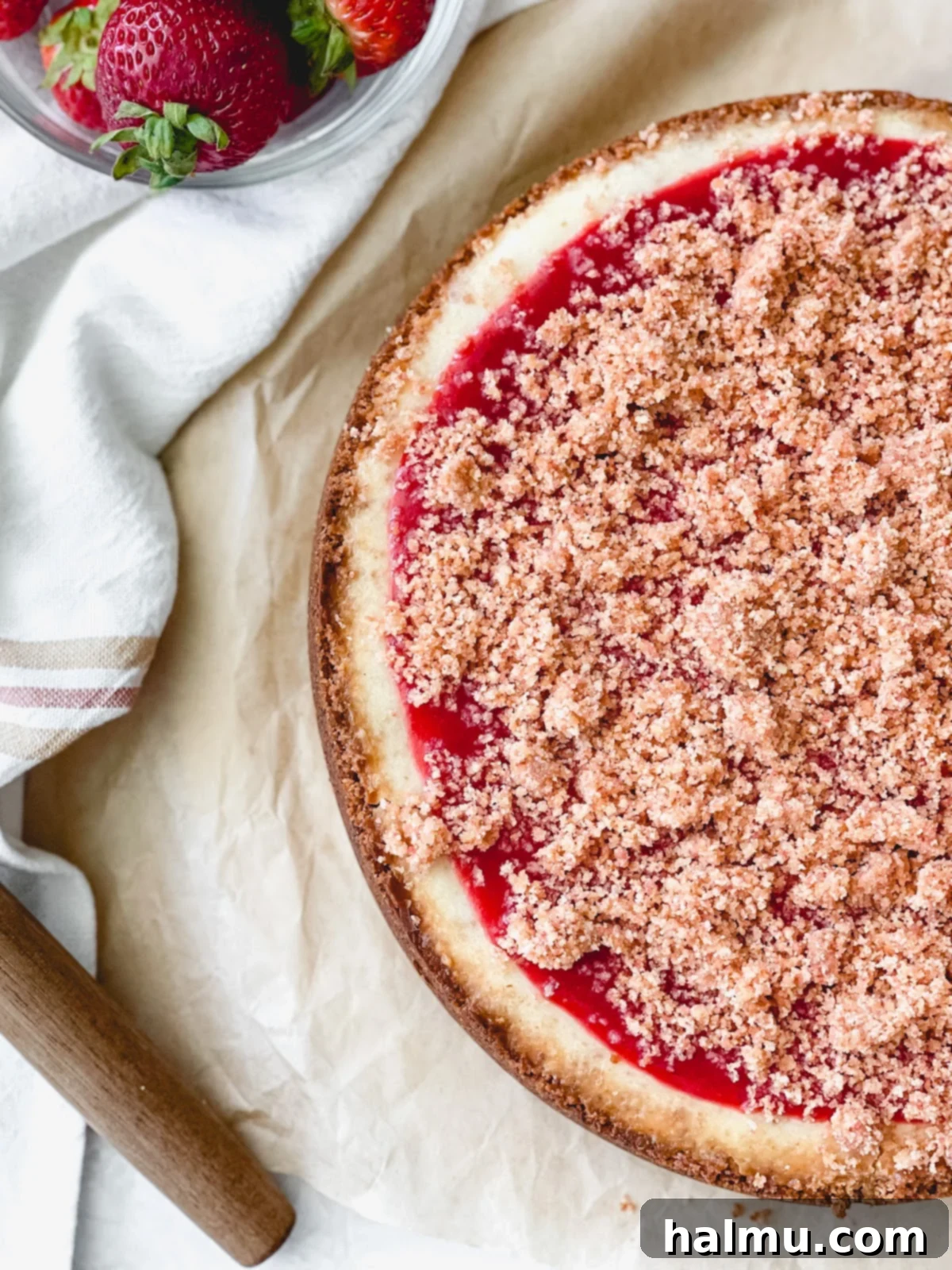 Close-up of the Strawberry Crunch Cheesecake showing the creamy filling and crumble.