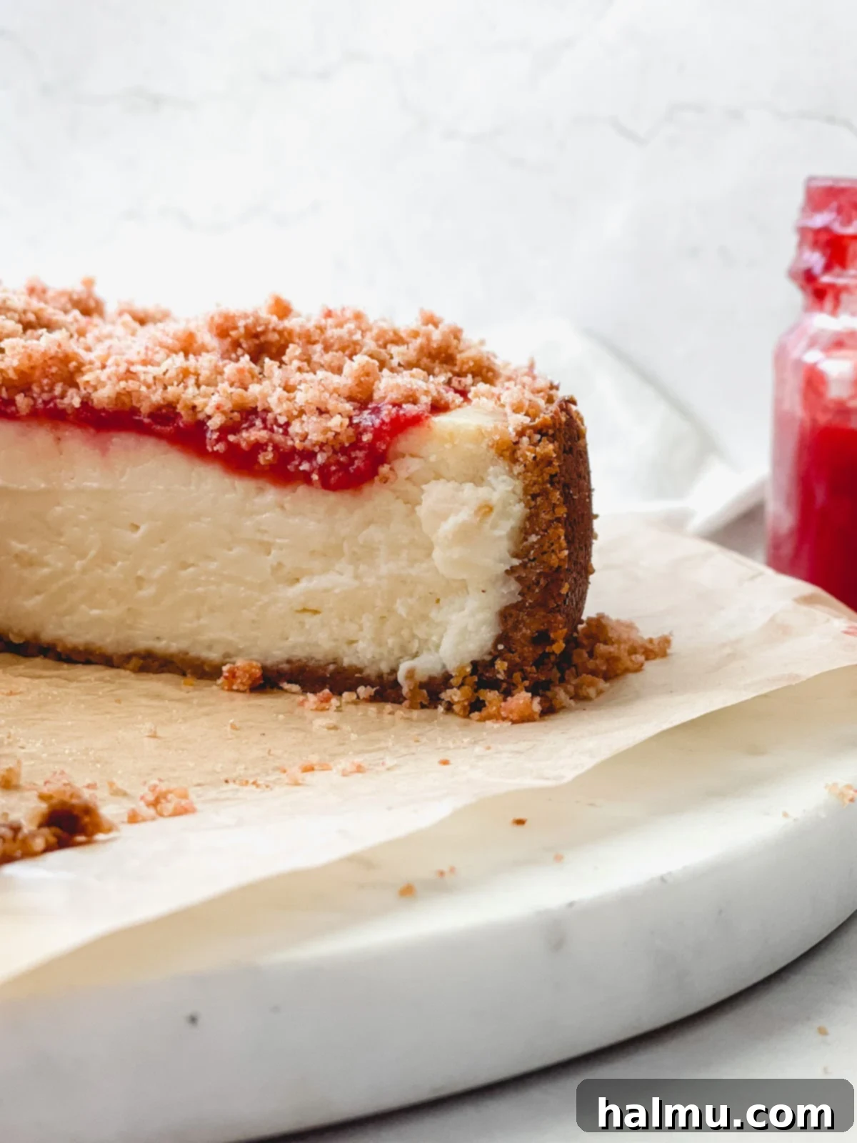 Side view of the Strawberry Crunch Cheesecake displaying its layers.