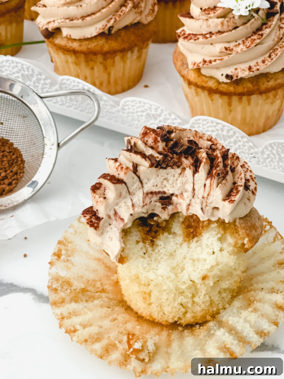 Decadent Tiramisu Cupcakes 4 A close-up of a Tiramisu Cupcake, showing the fluffy cake and creamy mascarpone frosting.