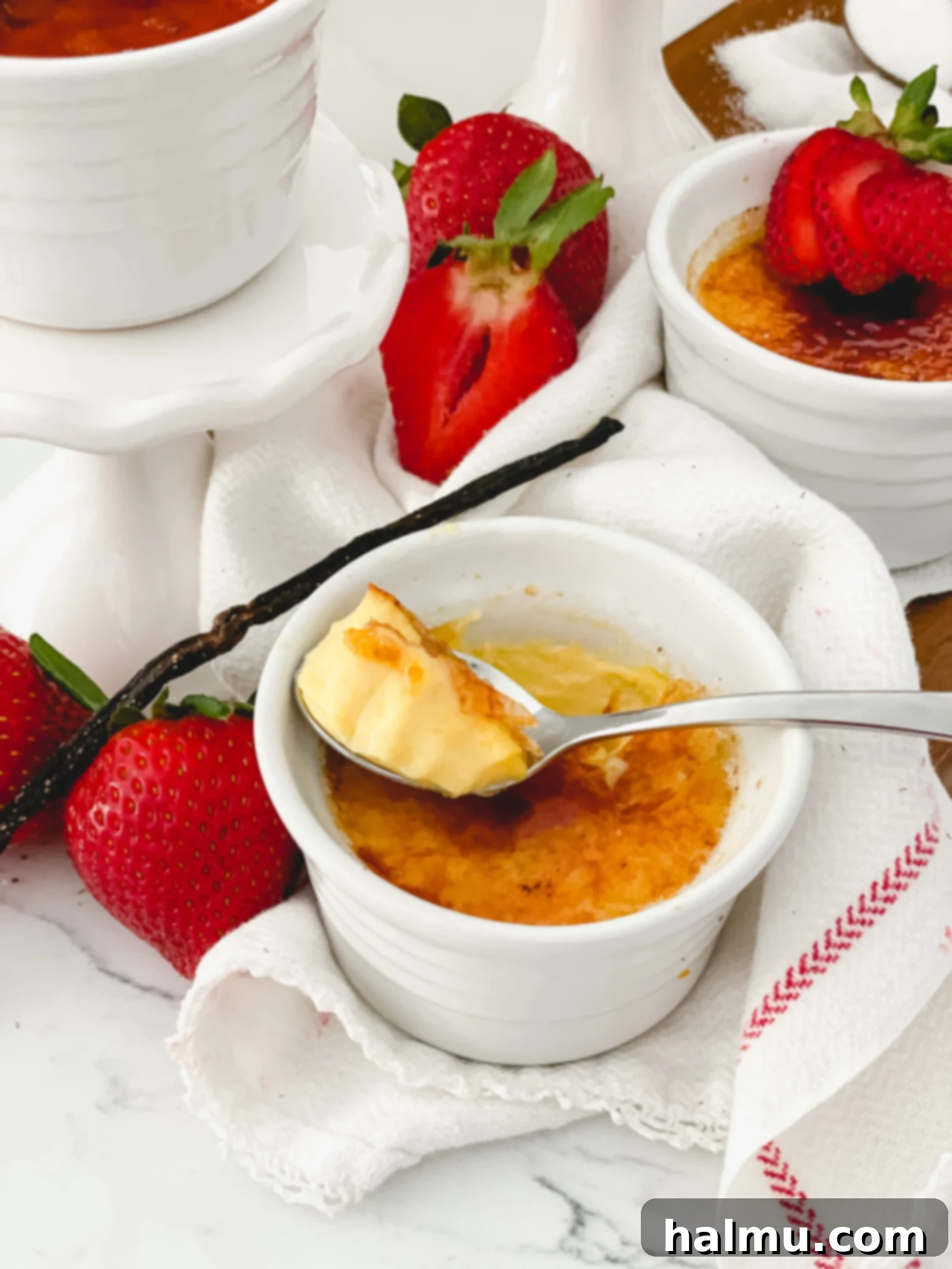 Rich Vanilla Bean Creme Brulee 2 A perfectly caramelized Vanilla Bean Crème Brûlée in a ramekin, showcasing the glossy, amber-colored sugar topping and the creamy custard beneath.