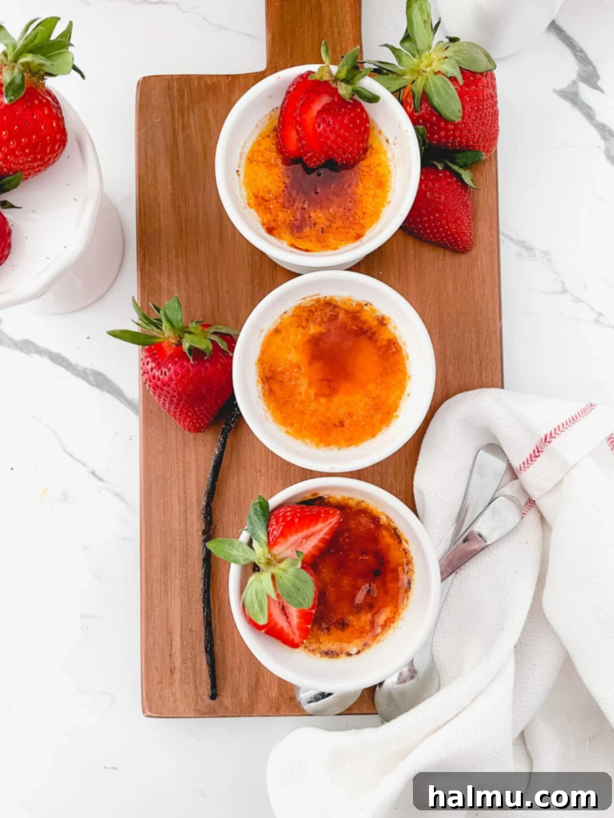 Rich Vanilla Bean Creme Brulee 3 Close-up of three ramekins filled with uncooked Crème Brûlée custard, ready for the water bath.