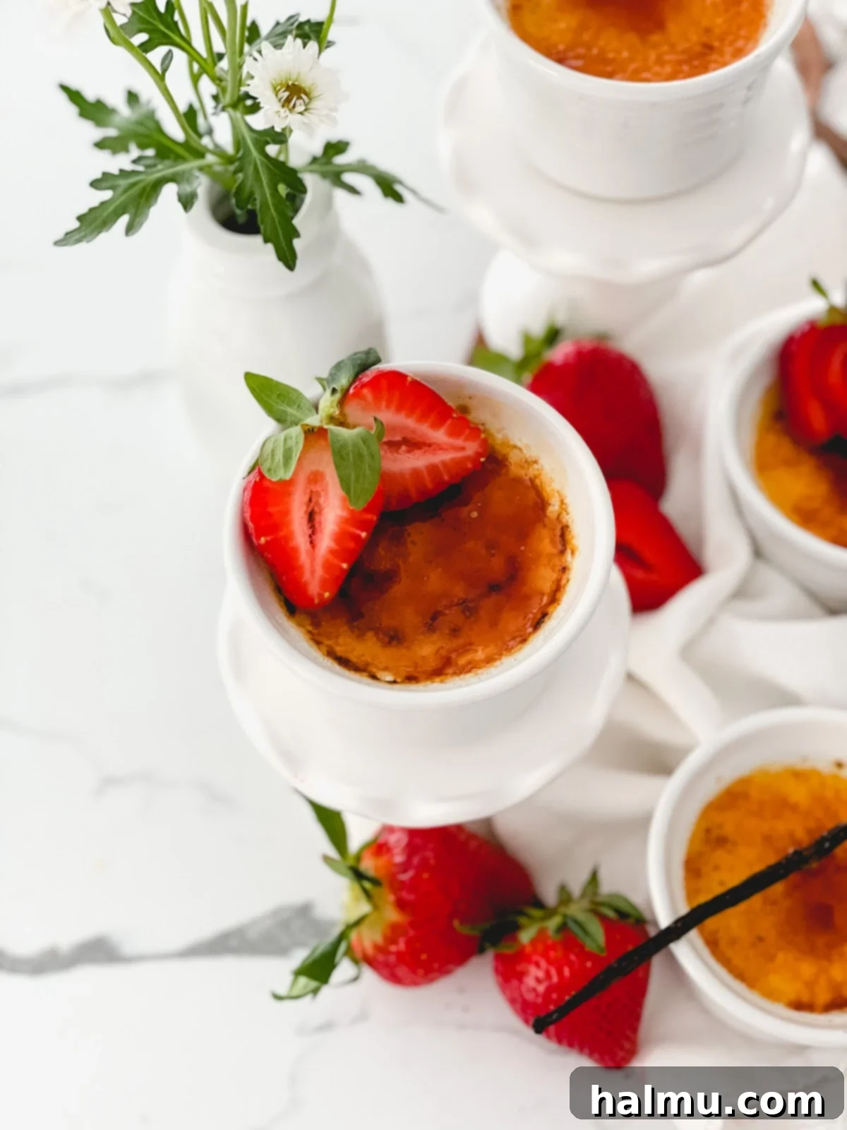 Rich Vanilla Bean Creme Brulee 4 A close-up shot of egg yolks being whisked with granulated sugar in a mixing bowl.
