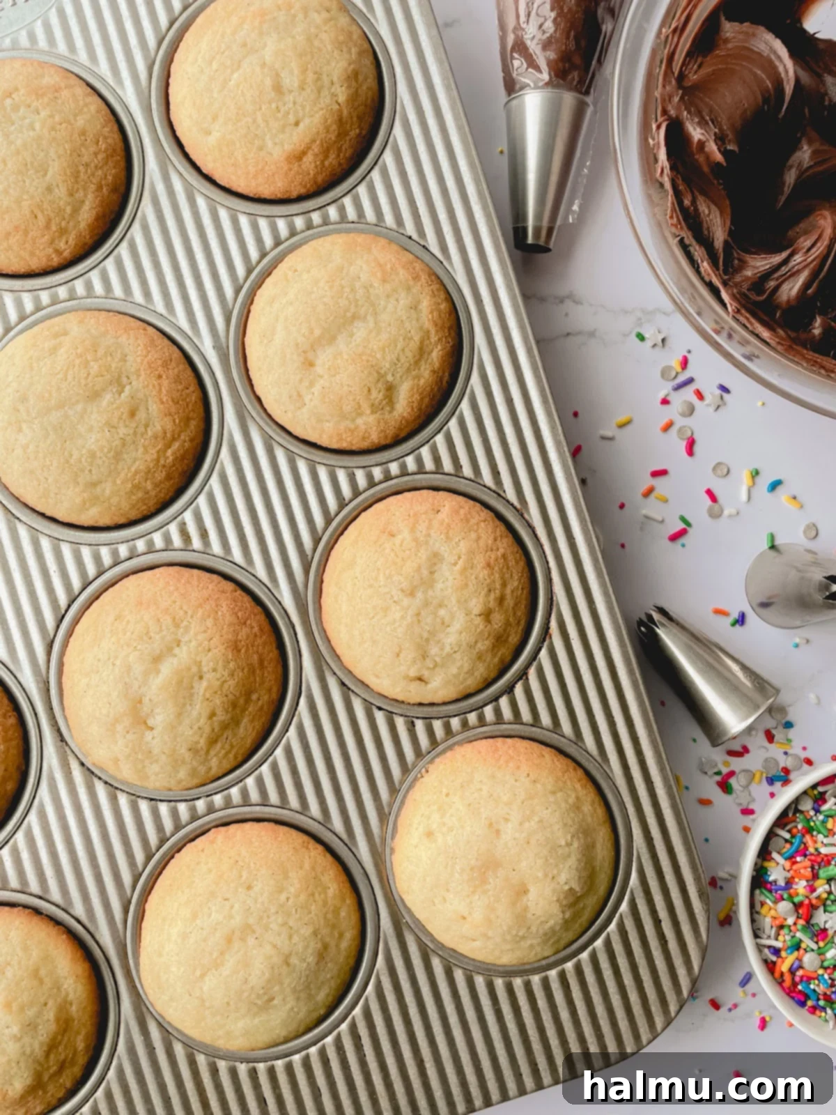 Step-by-step image: Filling a piping bag with chocolate cream cheese frosting by folding it over a glass