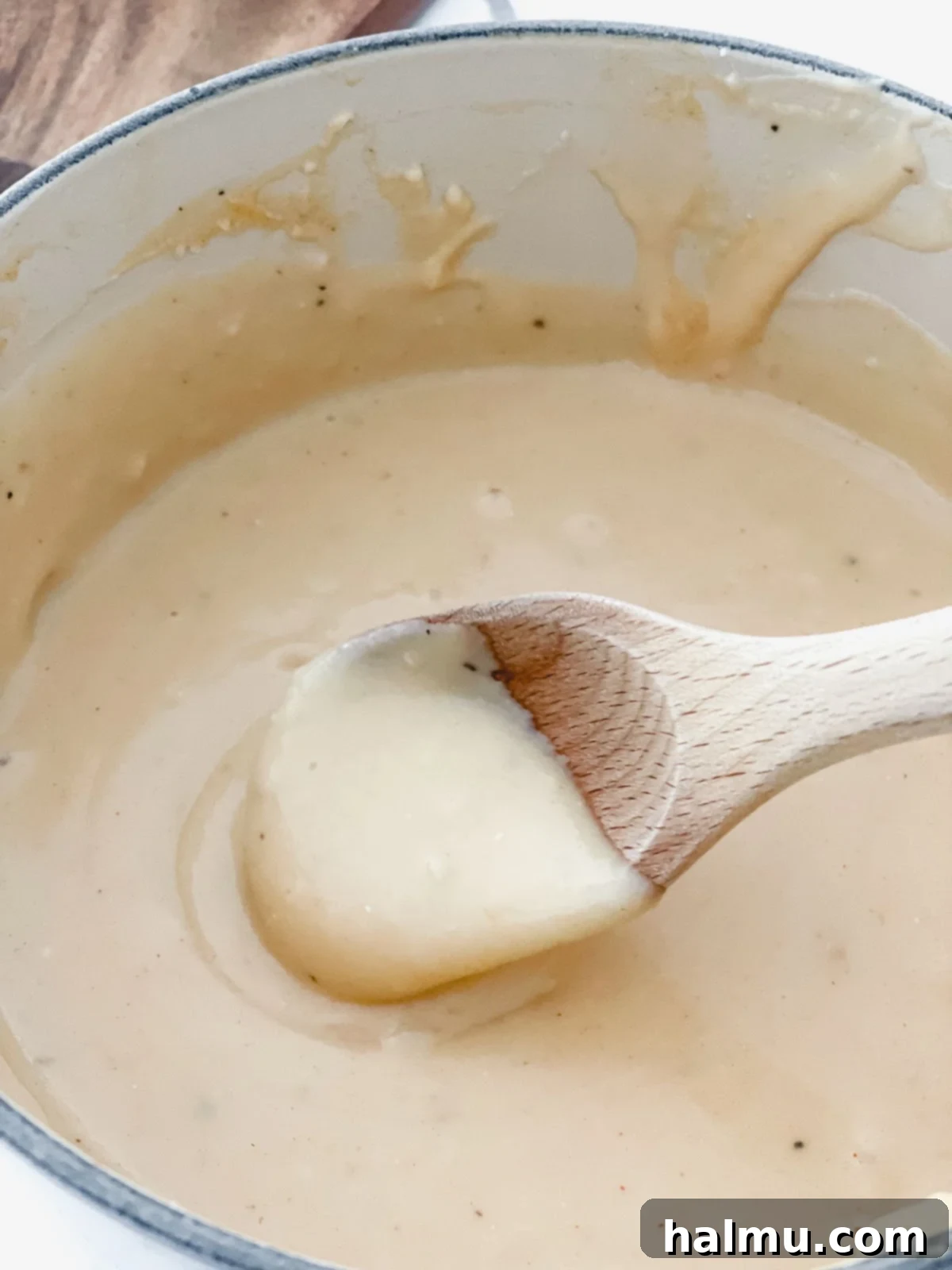 A bowl of Warm Beer Cheese Dip with various dippers like pretzels and vegetables