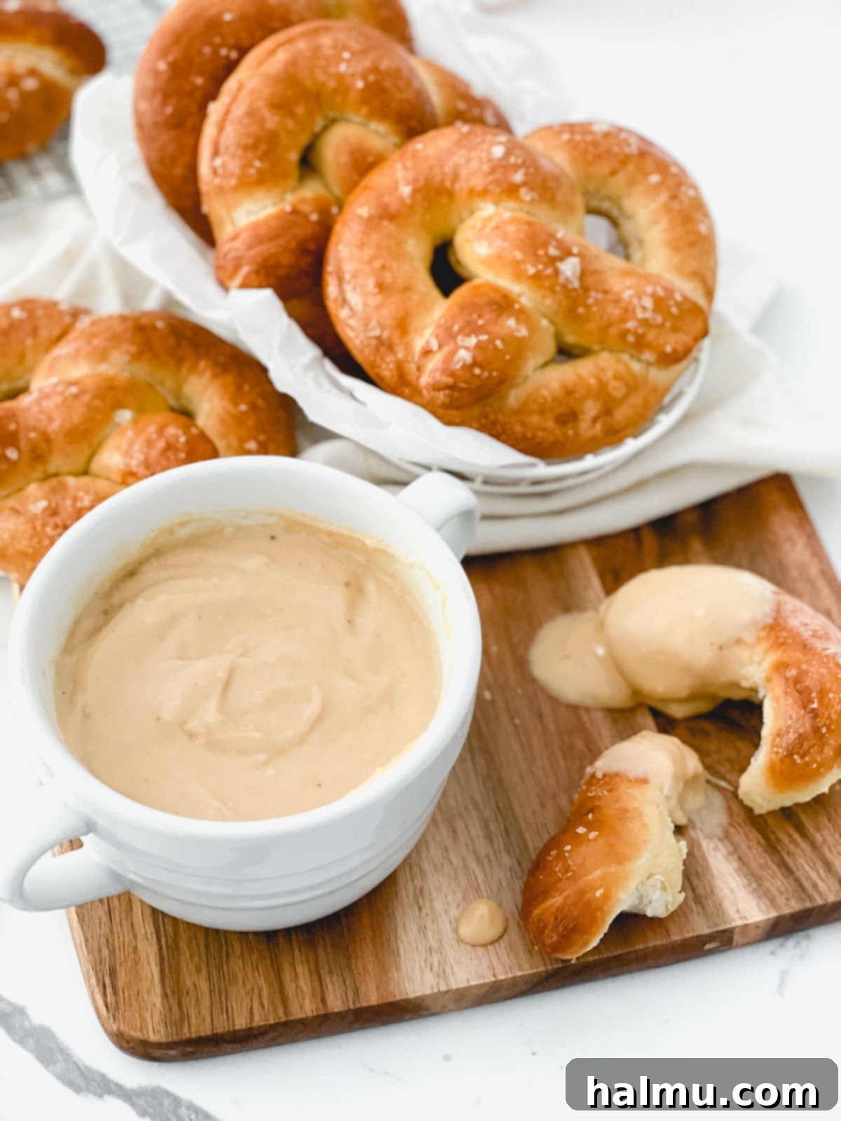 A close-up of a spoon scooping Warm Beer Cheese Dip, showing its creamy texture