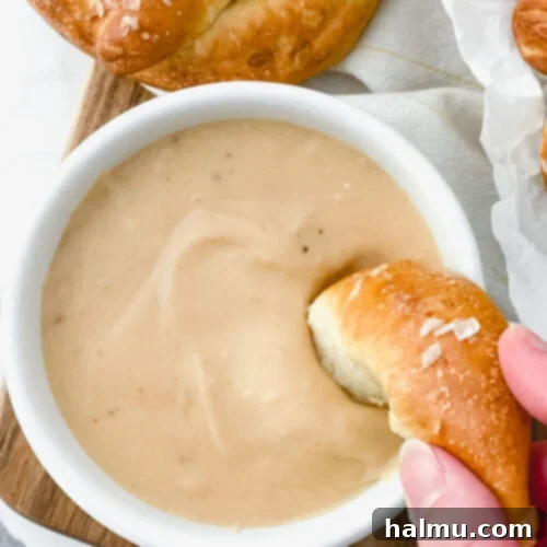 Warm Beer Cheese Dip served with homemade soft pretzels