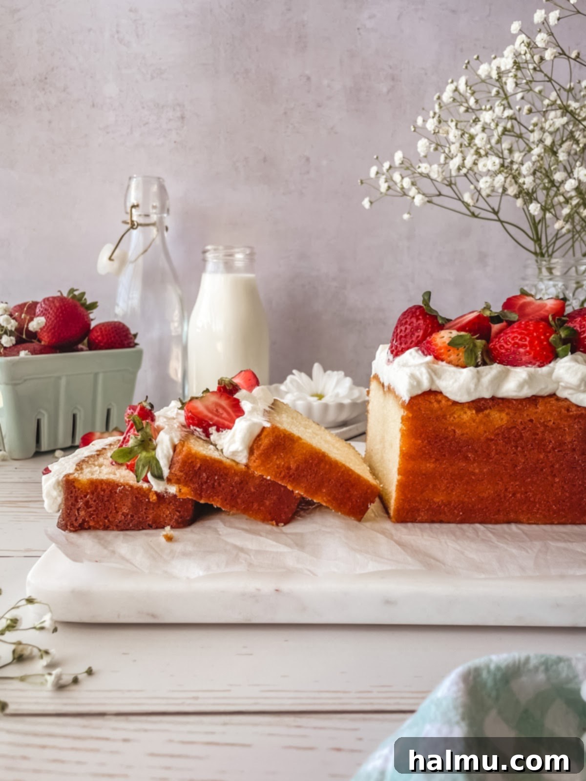 A slice of Yuzu Strawberry Pound Cake on a plate, garnished with mint