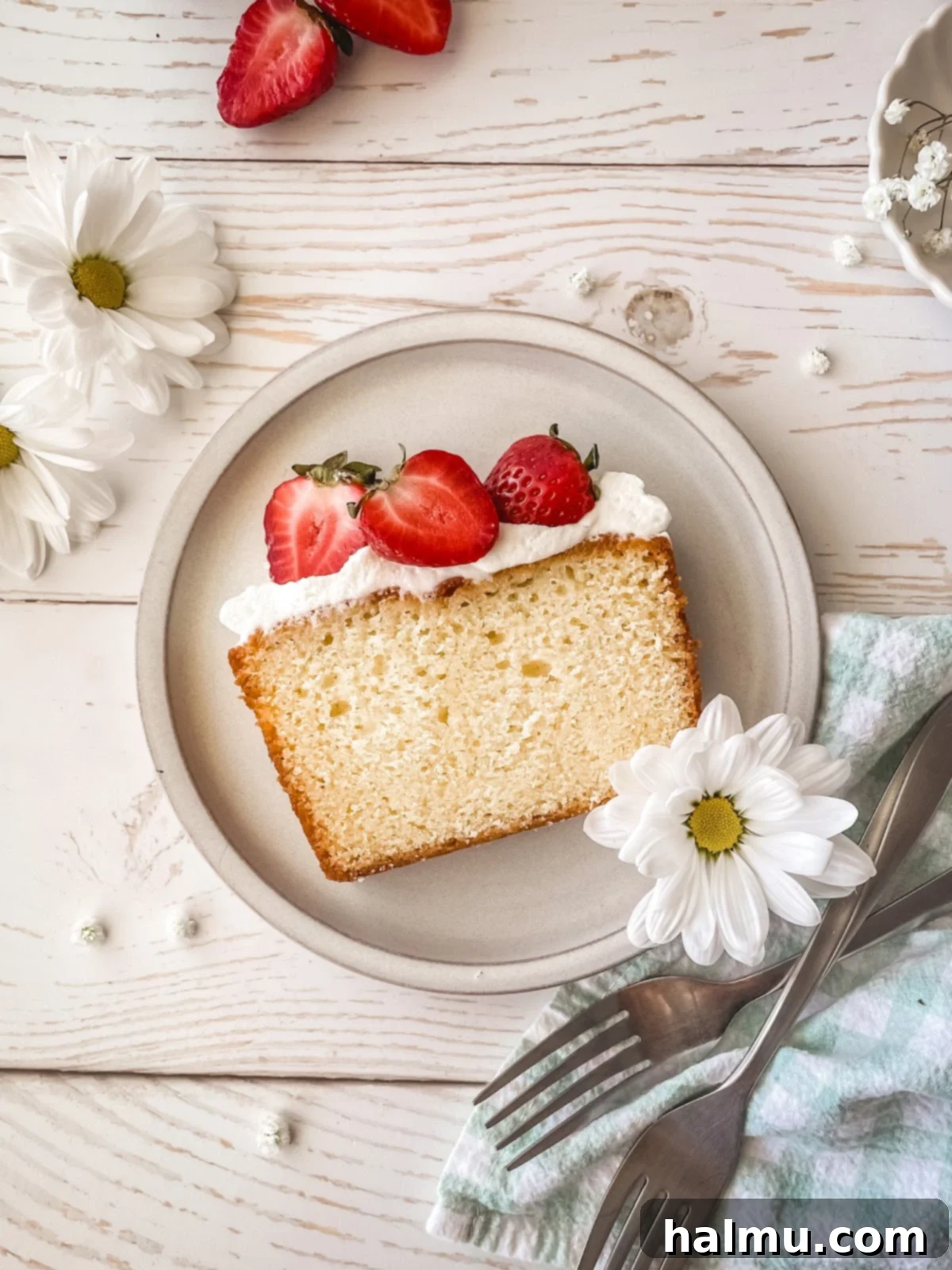 Beautifully arranged Yuzu Strawberry Pound Cake slices with fresh berries