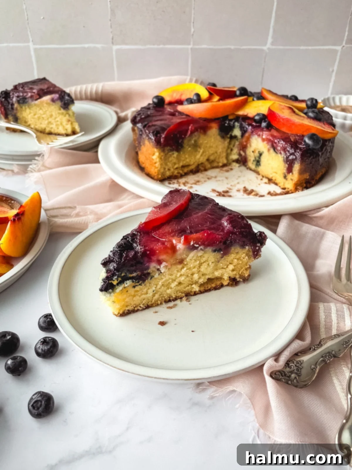 A close-up shot of the caramel and fruit topping of the Blueberry Nectarine Upside-Down Cake, ready for serving.