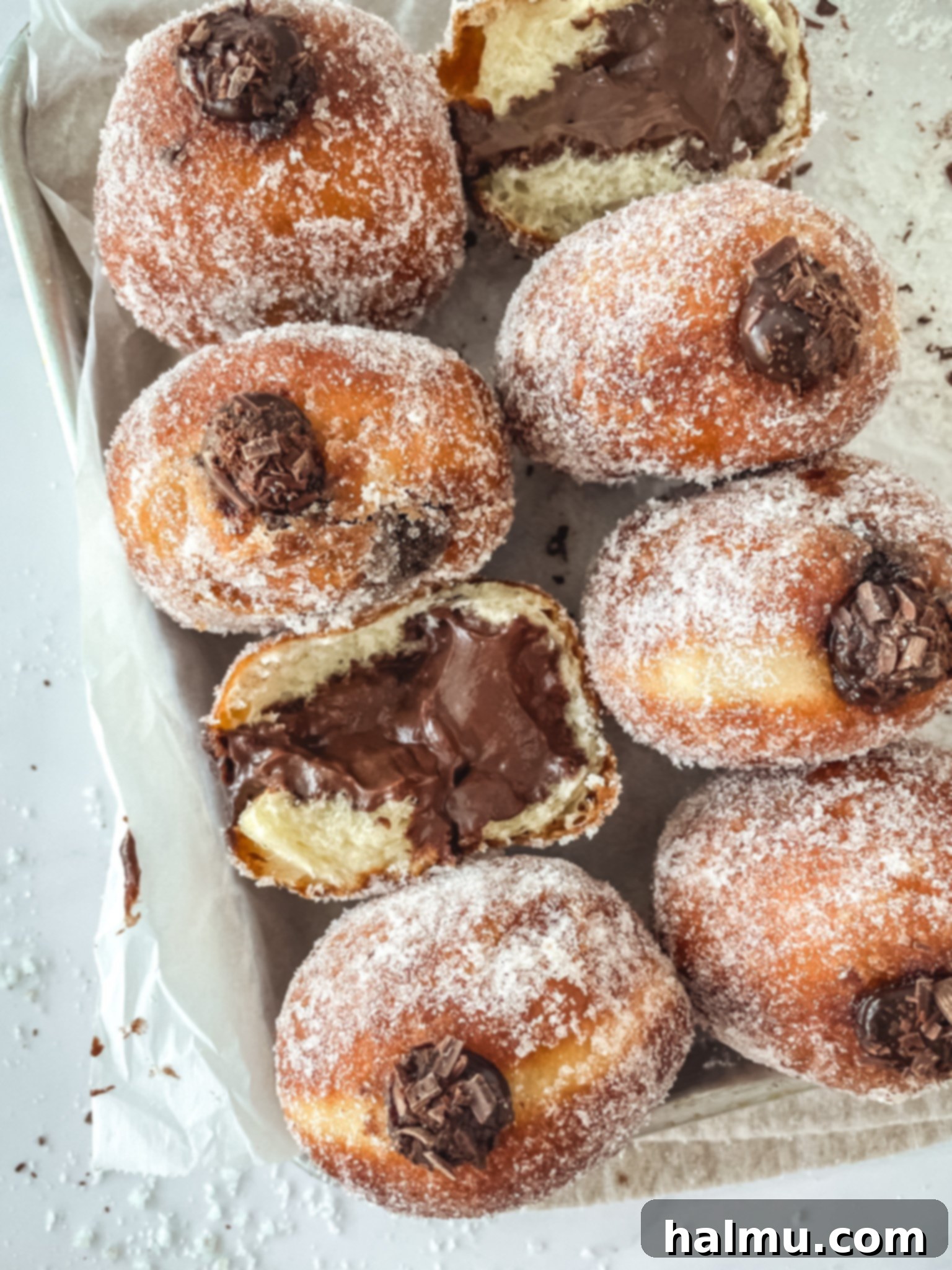 Decadent Chocolate Custard Brioche Donuts 2 A beautifully fried and sugared chocolate custard brioche donut, ready to be filled, showcasing its golden-brown exterior.