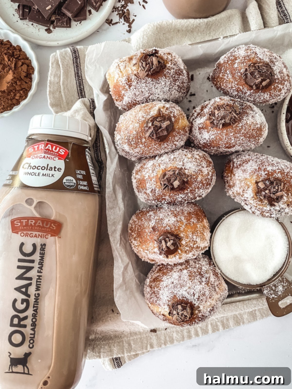 Decadent Chocolate Custard Brioche Donuts 3 A close-up of a stack of golden-brown brioche donut rounds, dusted with flour, ready for their first rise.